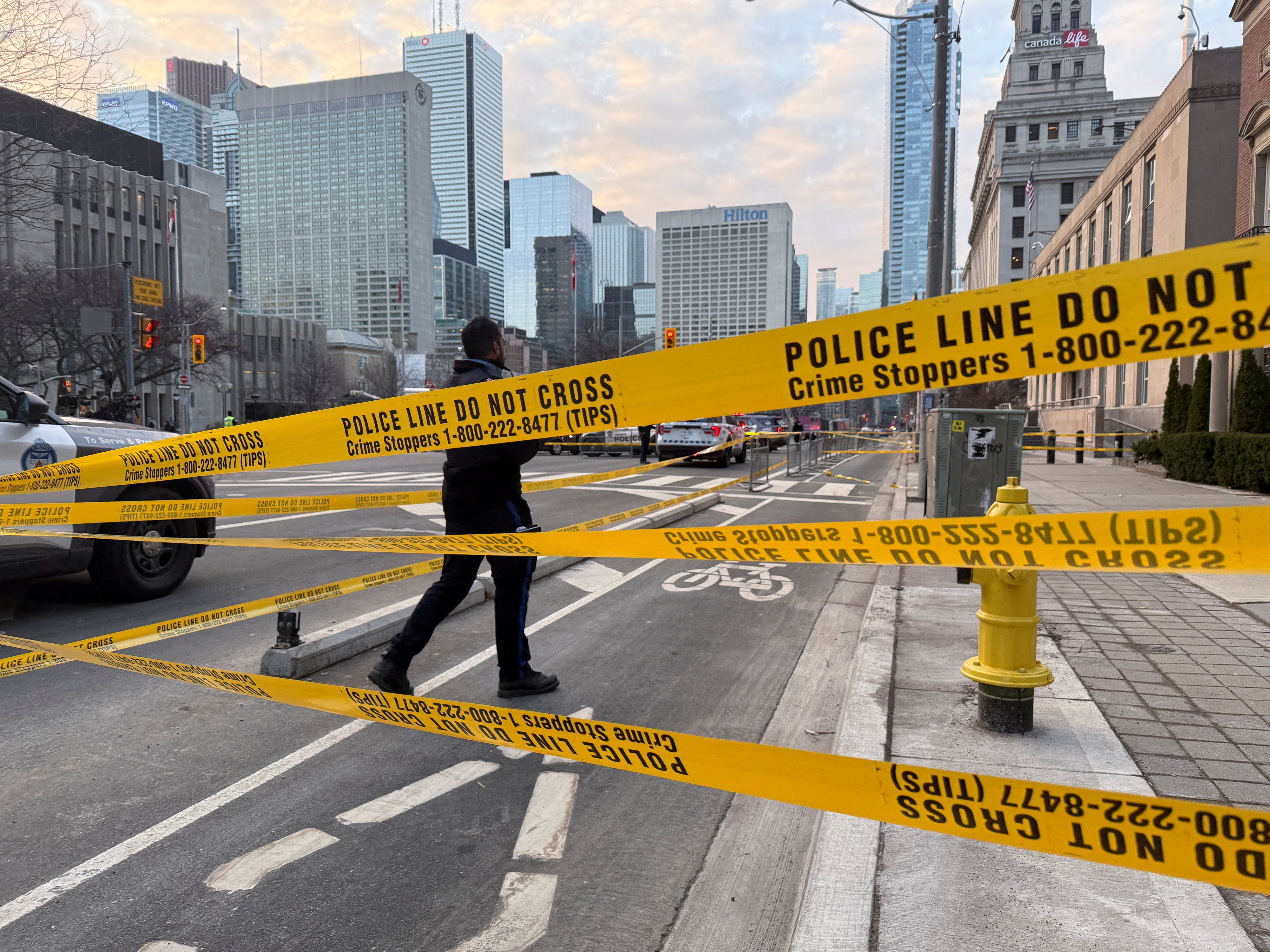 A law enforcement officer works outside the US consulate after shots were fired in Toronto on Tuesday. Photo: Reuters