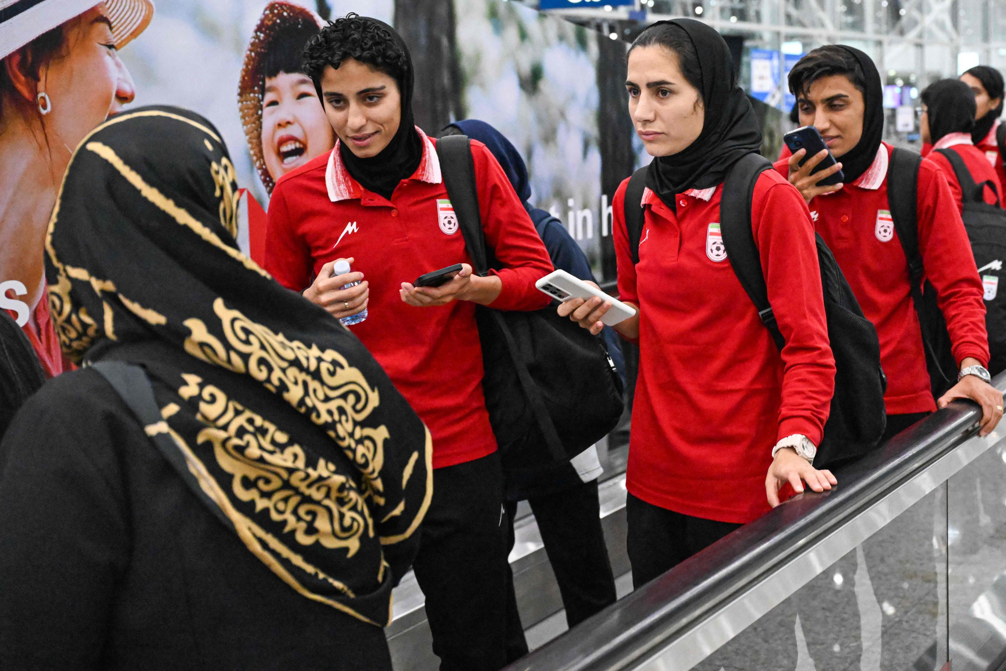 Members of Iran’s women’s football delegation arrive at the Kuala Lumpur International Airport on their way home from the Women’s Asia Cup in Australia. Photo: AFP