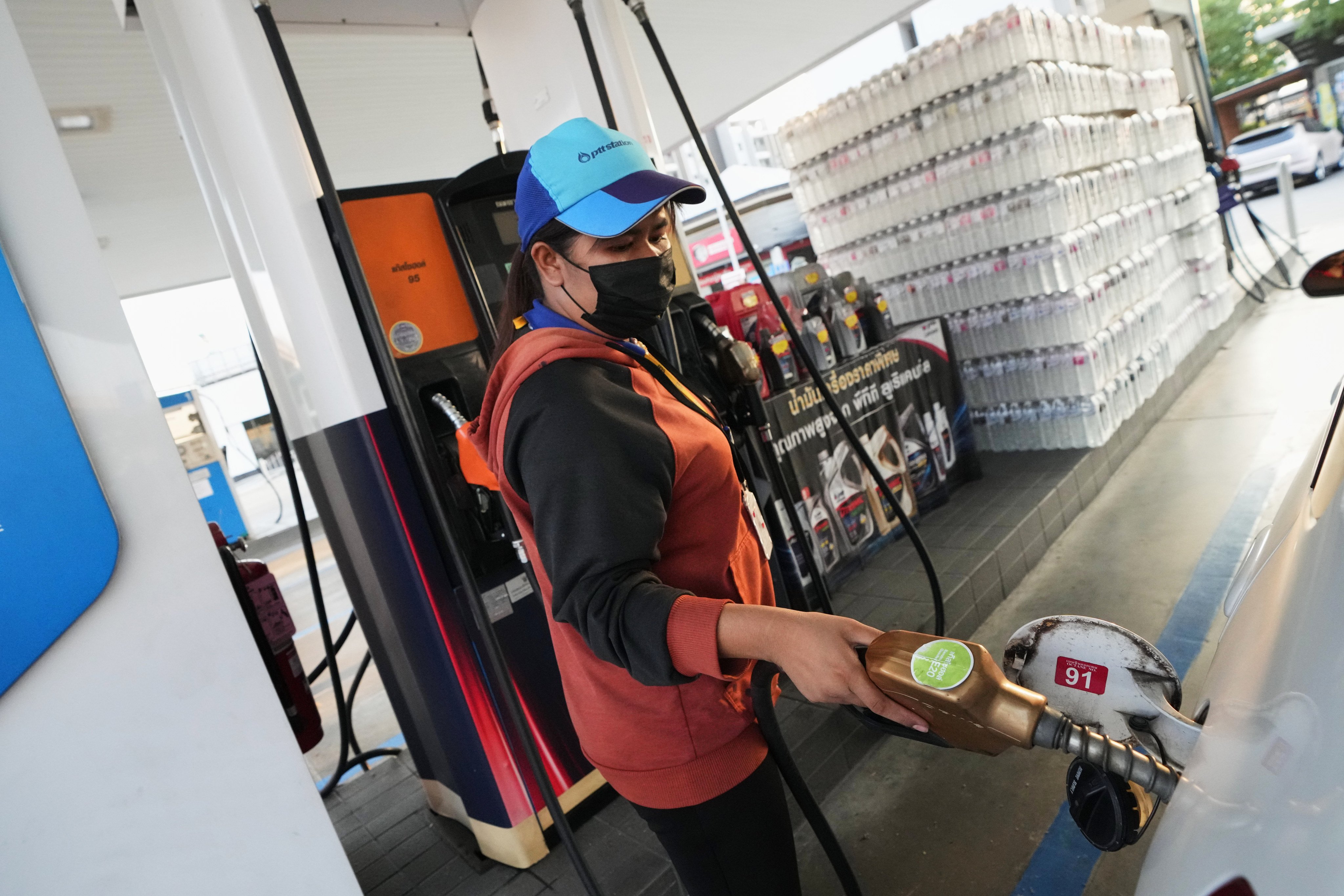 A petrol station attendant fills the tank of a car in Bangkok, Thailand, on Monday. Some drivers have begun panic buying diesel amid fears of a fuel shortage. Photo: AP