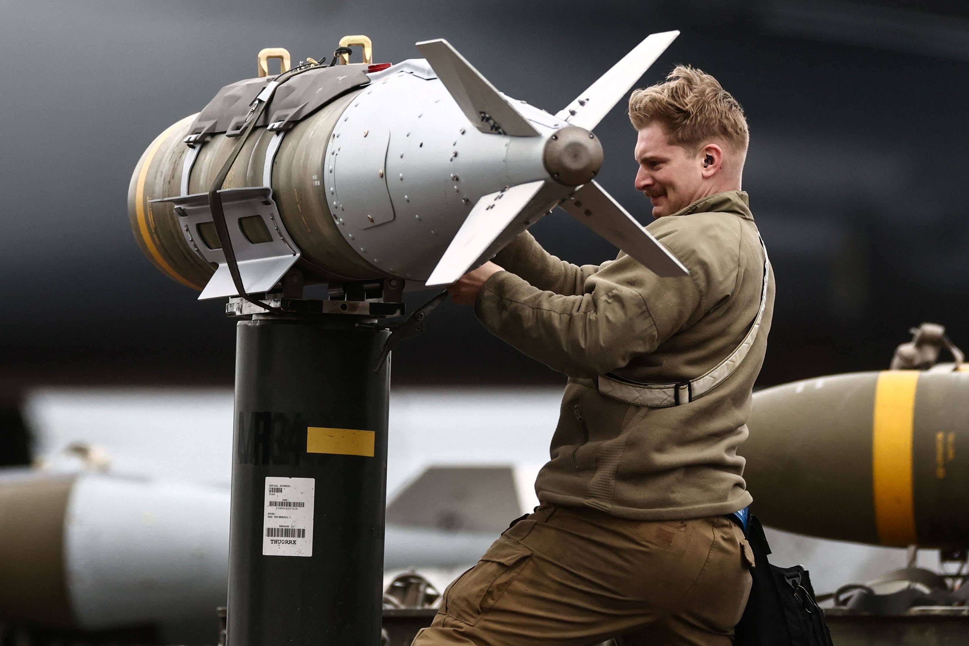 US Air Force military ground personnel prepare munitions for a bomber on Thursday. Photo: AFP