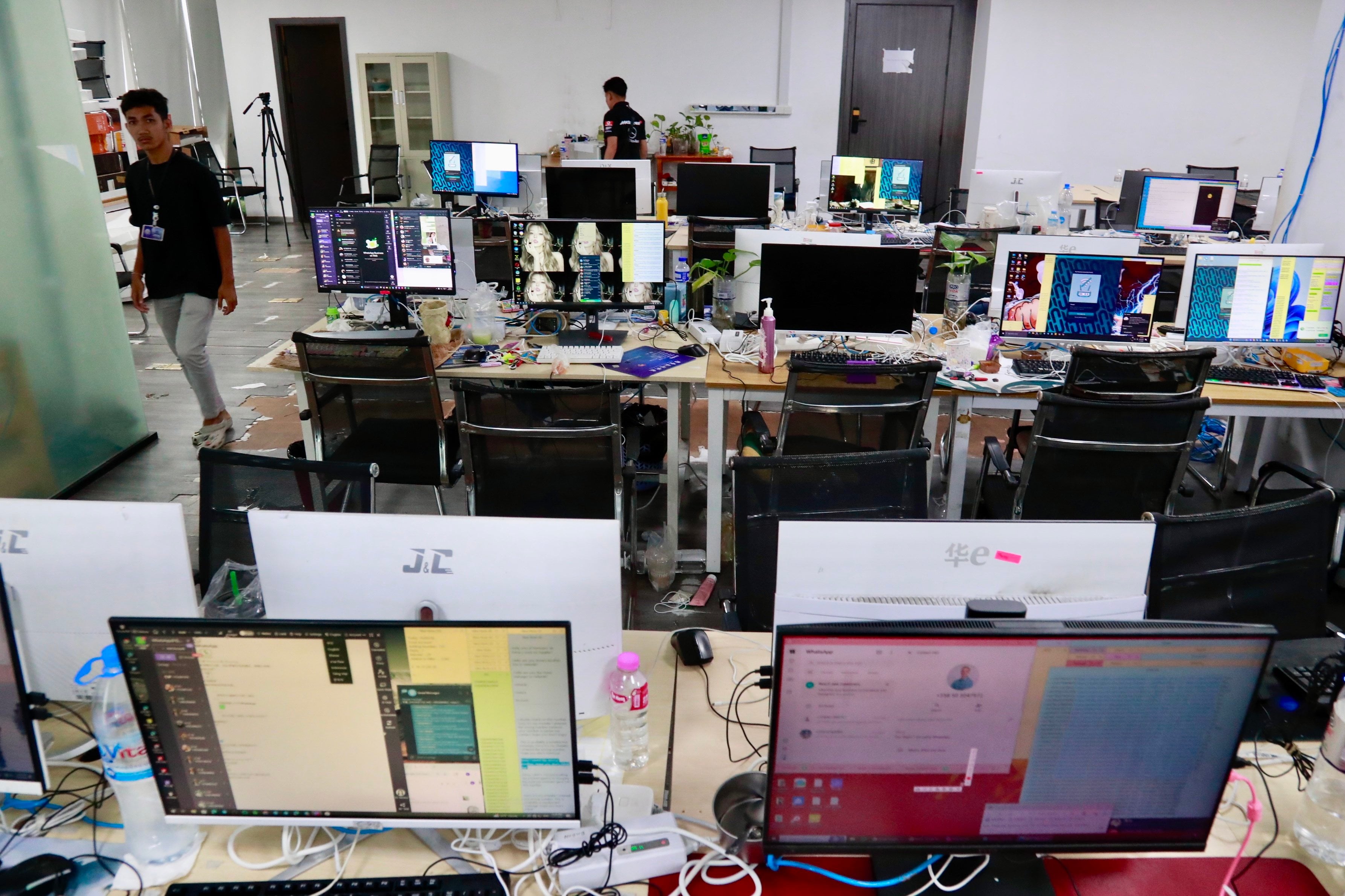 Workstations used by scam operators are seen after a police raid in Phnom Penh on Wednesday. Photo: EPA