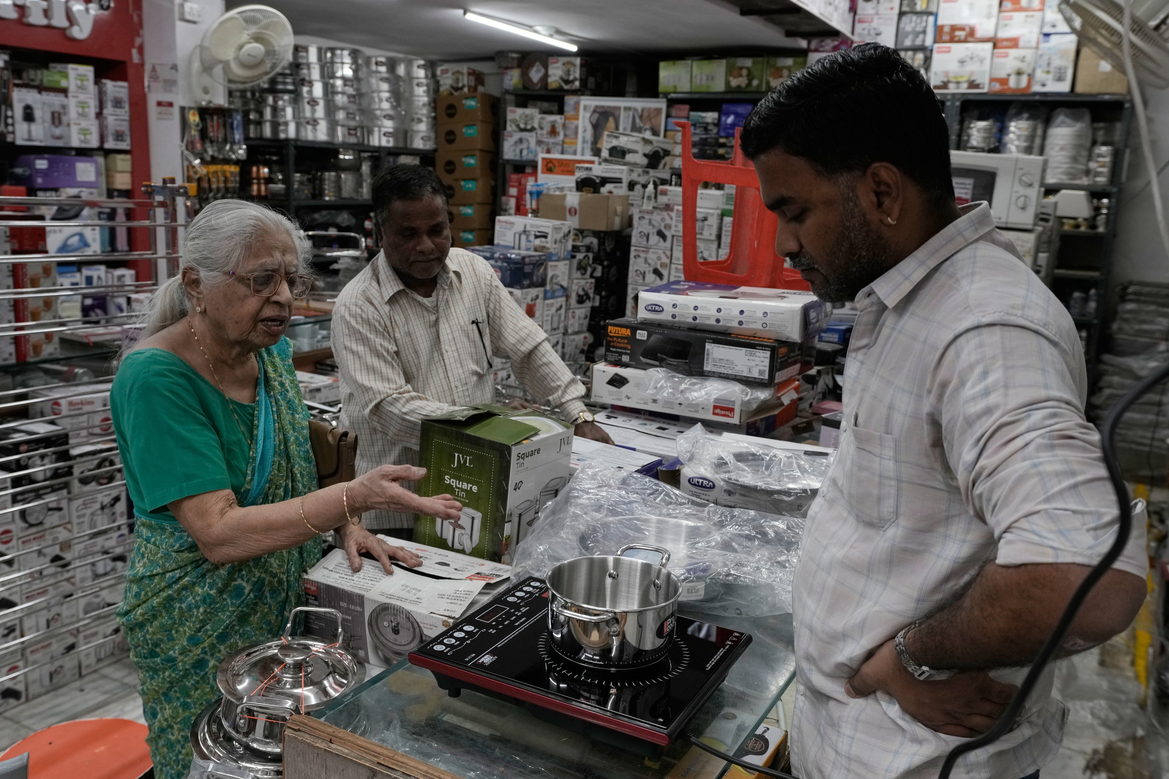 A customer shops for an induction stove at a store in Hyderabad, India, on Wednesday. Photo: AP