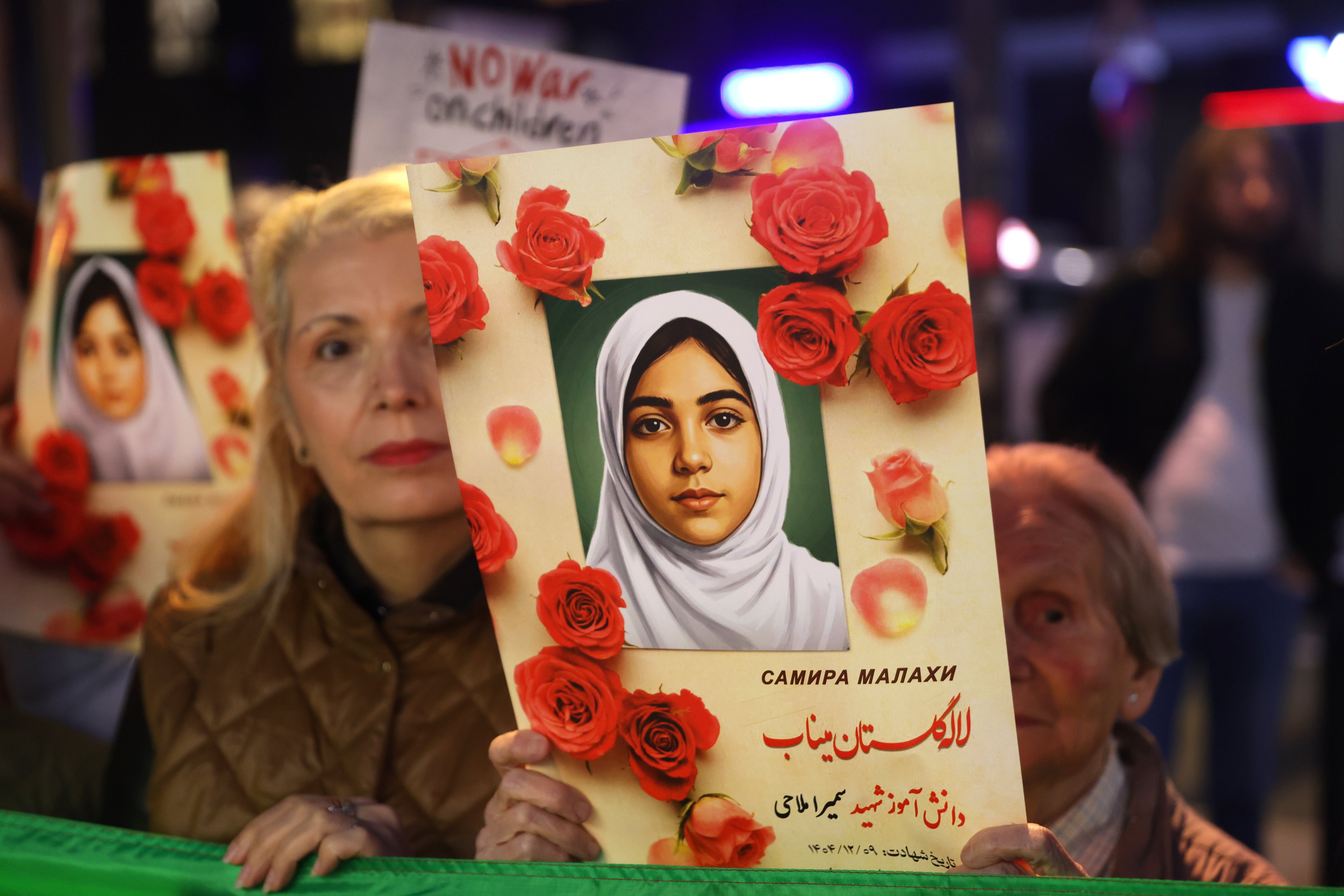 A protester holds a photograph of a young girl reportedly killed in the bombing of a school in Minab, Iran, during a solidarity rally in Belgrade, Serbia, on Tuesday. Photo: EPA