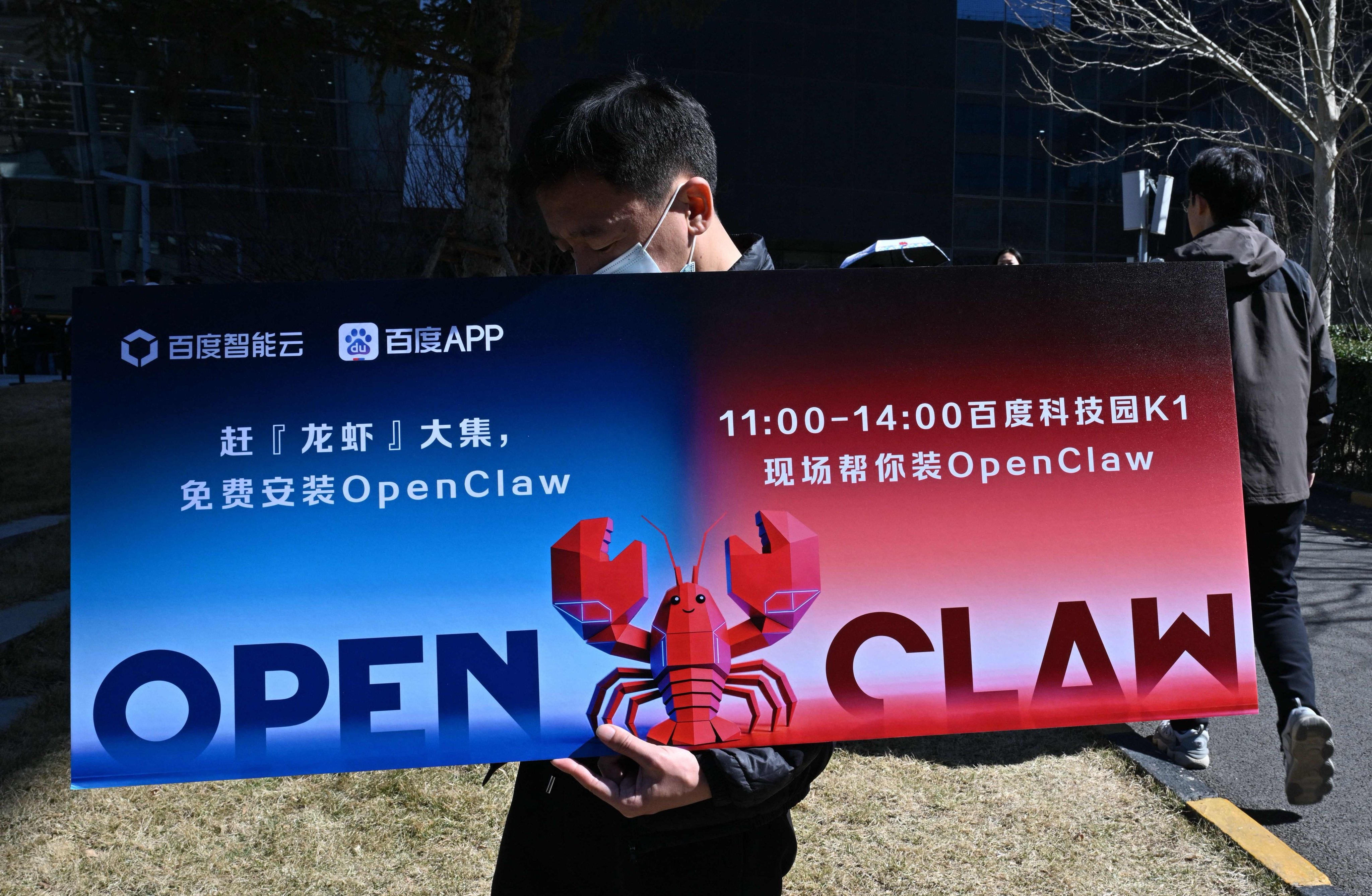 A man holds a placard featuring OpenClaw, an open-source AI assistant in Beijing on March 11. Photo: AFP