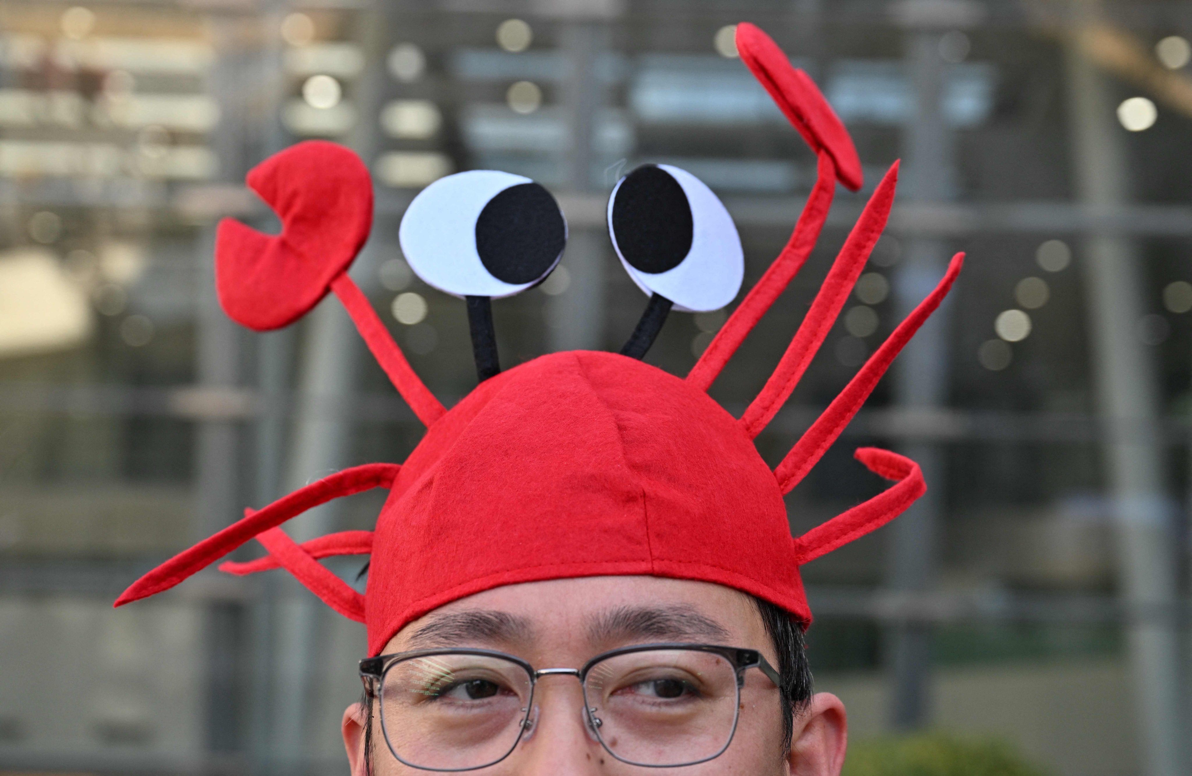 A man wears a lobster hat representing the OpenClaw logo at Baidu’s headquarters in Beijing. Photo: AFP