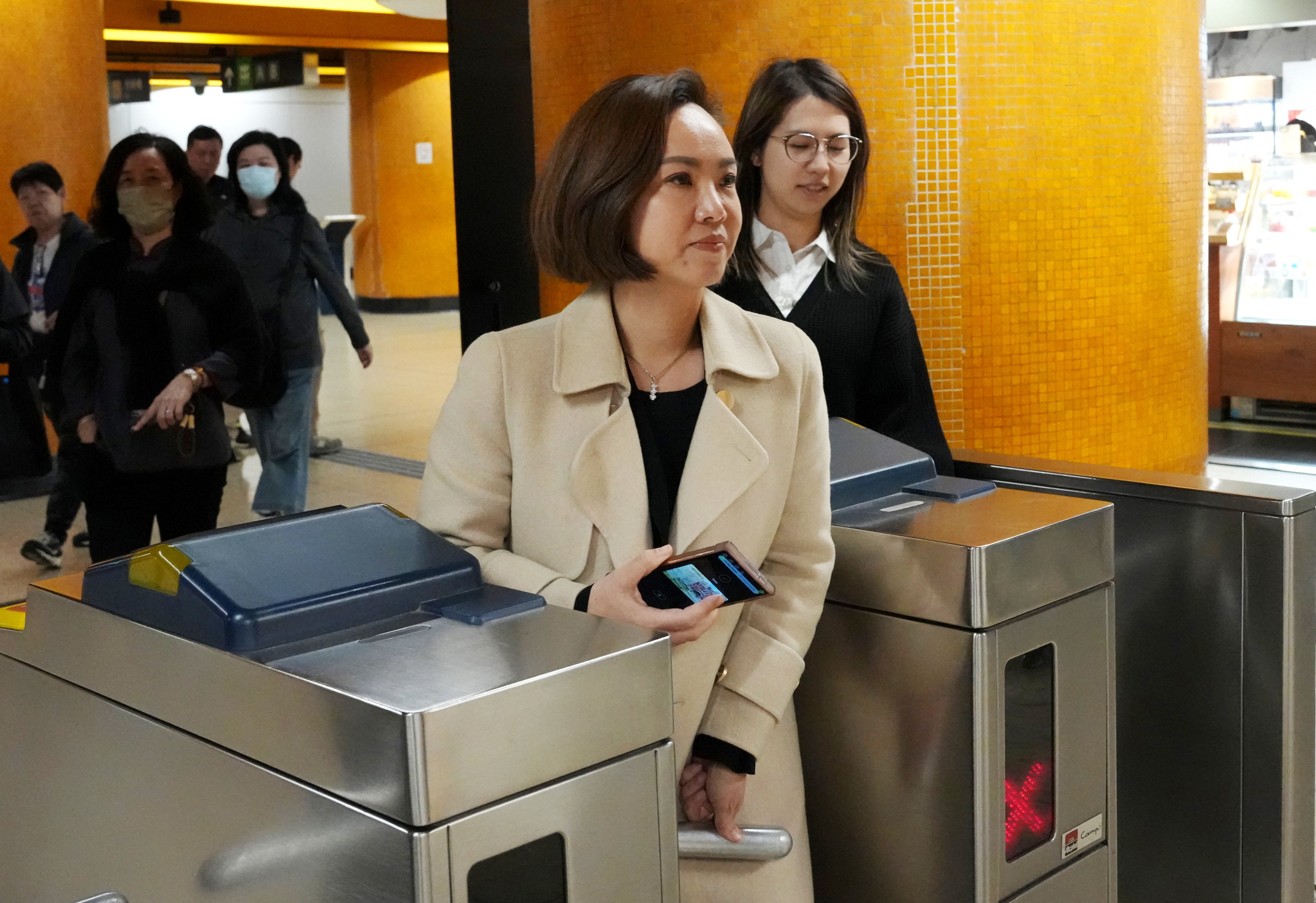 Judy Chan passes through a gate at an MTR station, opting for public transport as she leaves Eastern Court after receiving a fine on March 9. Photo: Jelly Tse