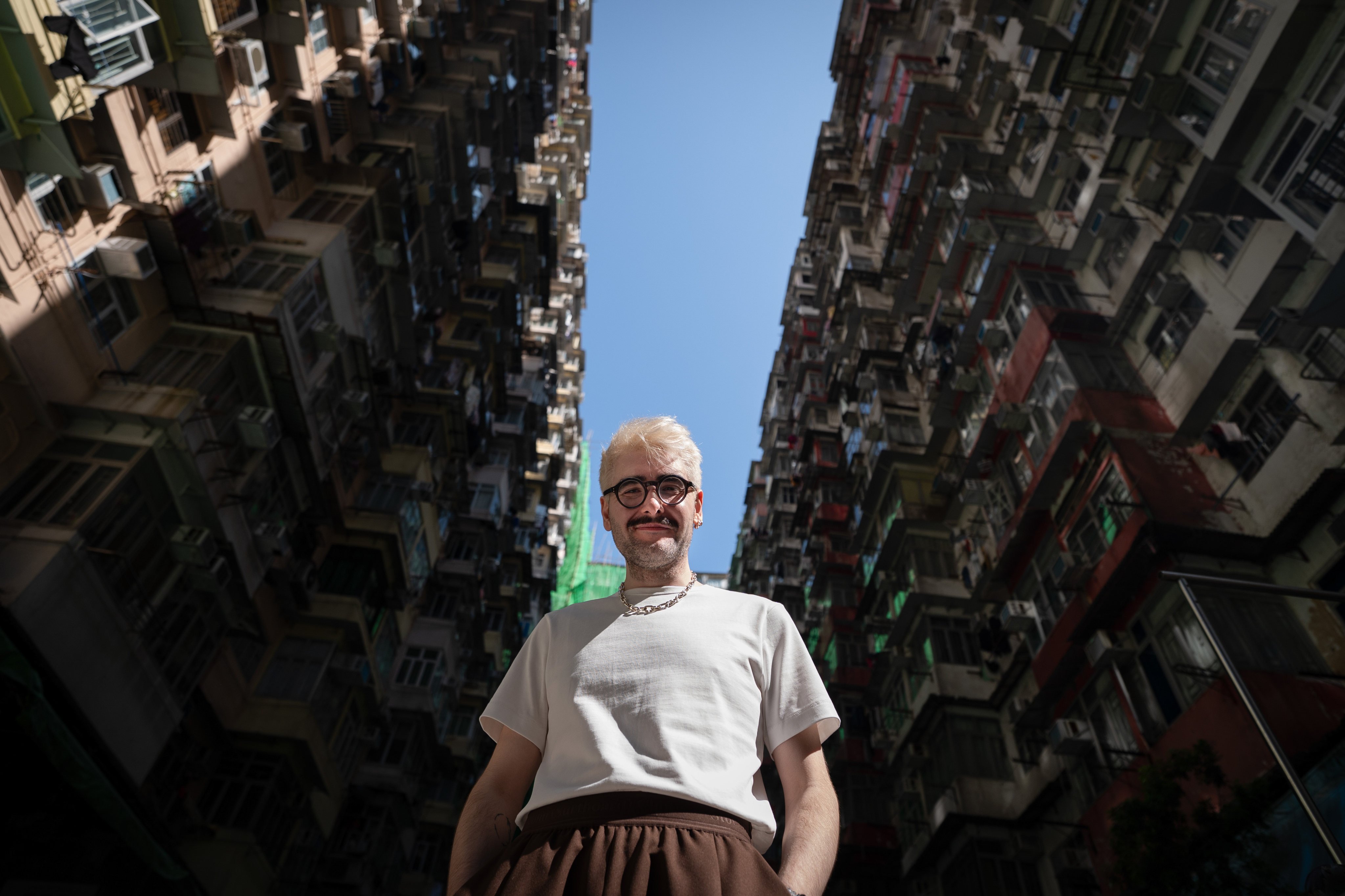 James Taylor-Foster poses for a photo in front of the “Monster Building” in Quarry Bay. He is the newly appointed executive director of Para Site art space in Hong Kong. Photo: Elson Li