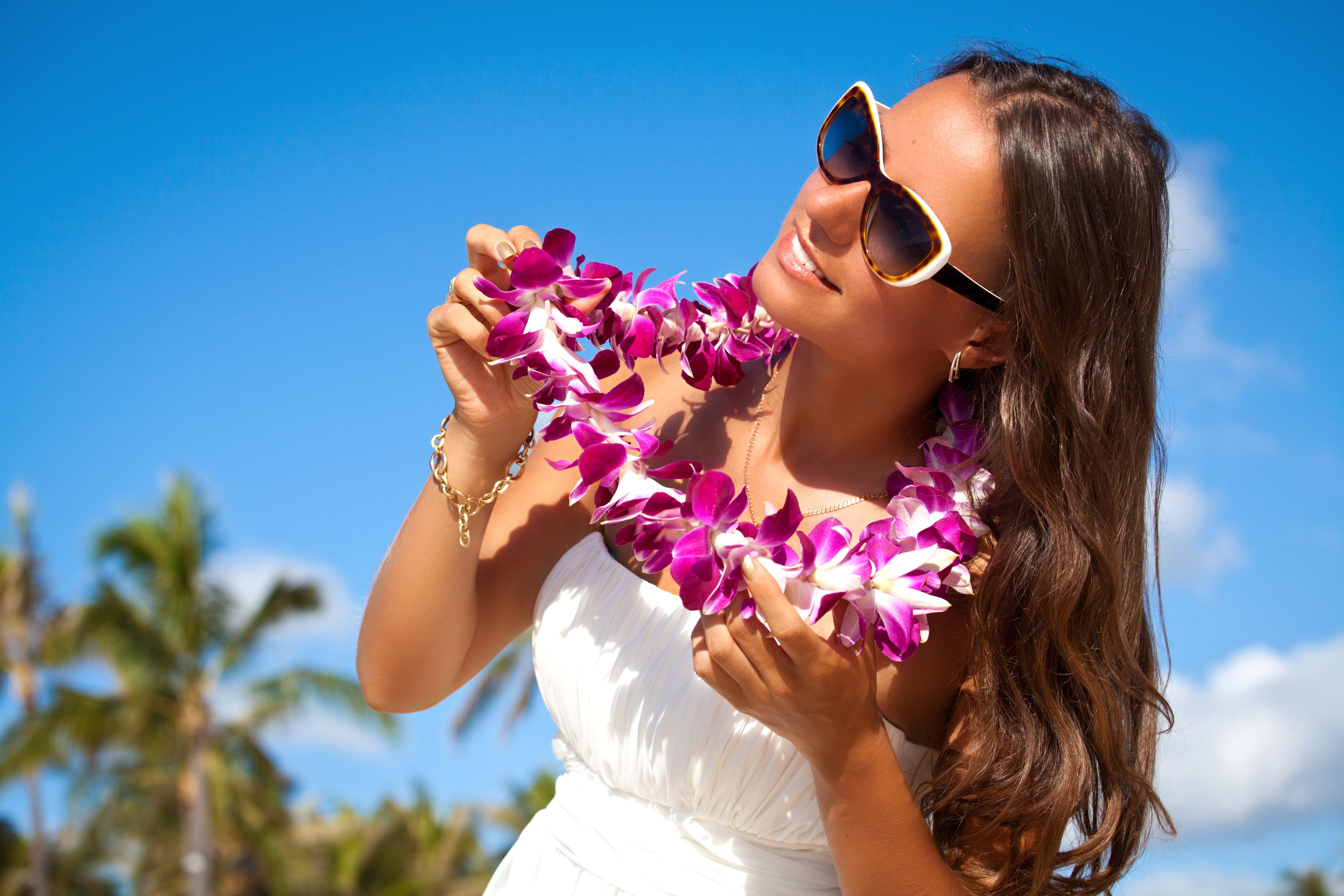 A woman wears a lei, a traditional floral adornment given to welcome visitors, celebrate milestones or honor someone’s achievements. Hawaiian lei are often made with imported flowers, sparking debate on supporting local growers to preserve their cultural significance. Photo: Getty Images