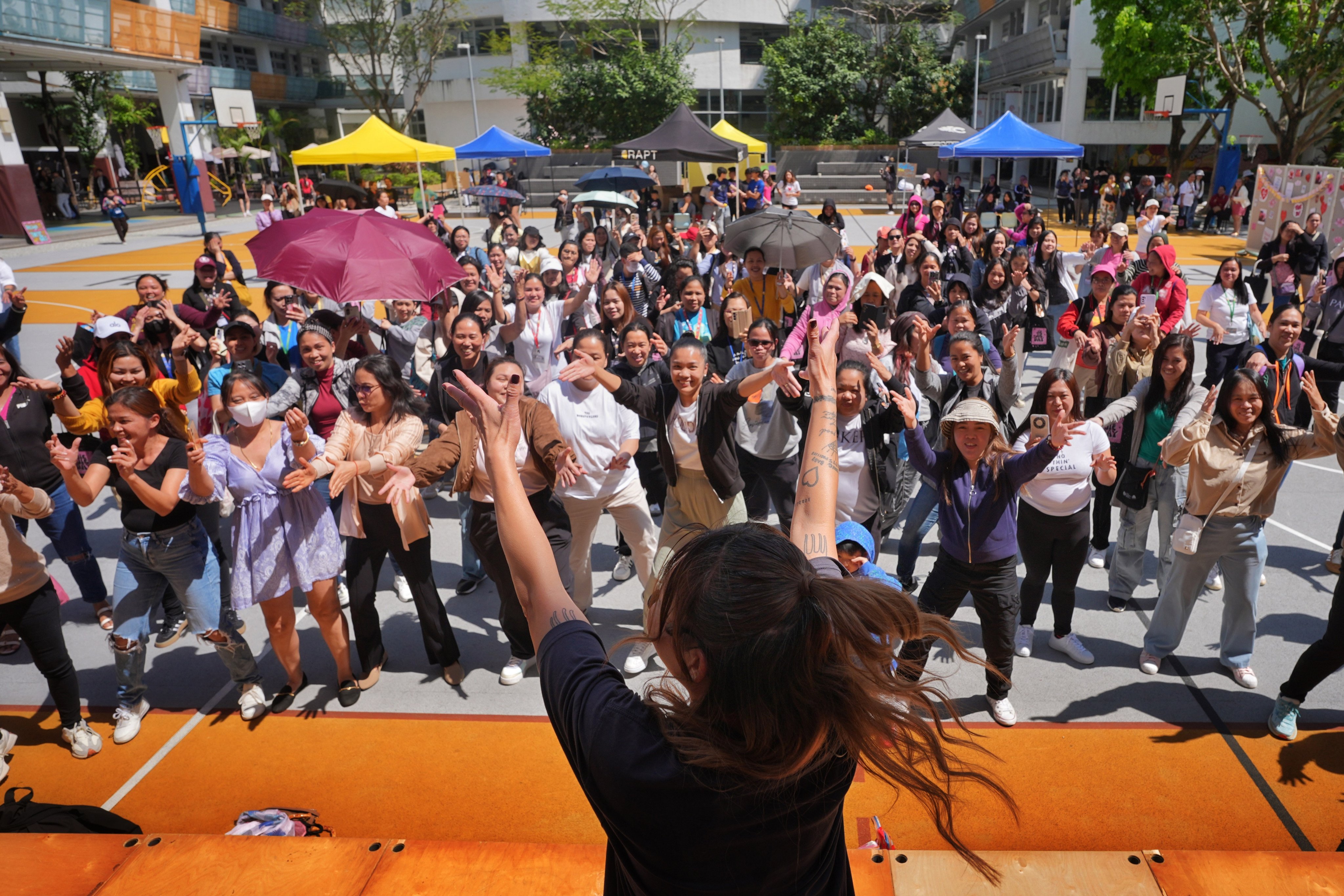 Hundreds of domestic helpers participate in an activity on “Jie Jie Day” organised by students of Renaissance College Hong Kong. Photo: Elson Li