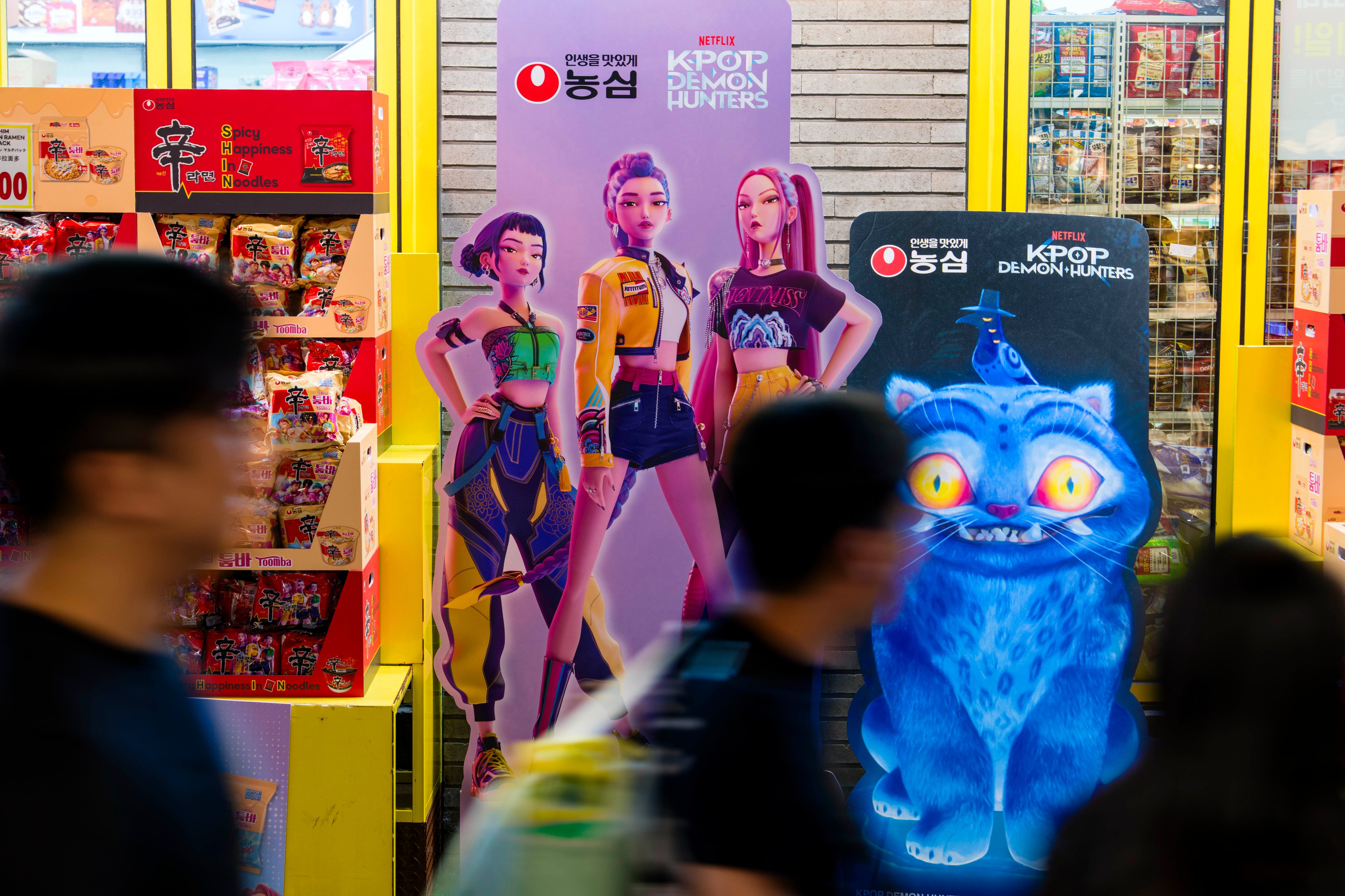 Promotional material for instant noodles and snacks themed after the Netflix movie KPop Demon Hunters is displayed outside a shop in the tourist district of Myeongdong in Seoul. The South Korean capital has benefitted from a tourism wave linked to the movie’s popularity. Photo: The Washington Post via Getty Images