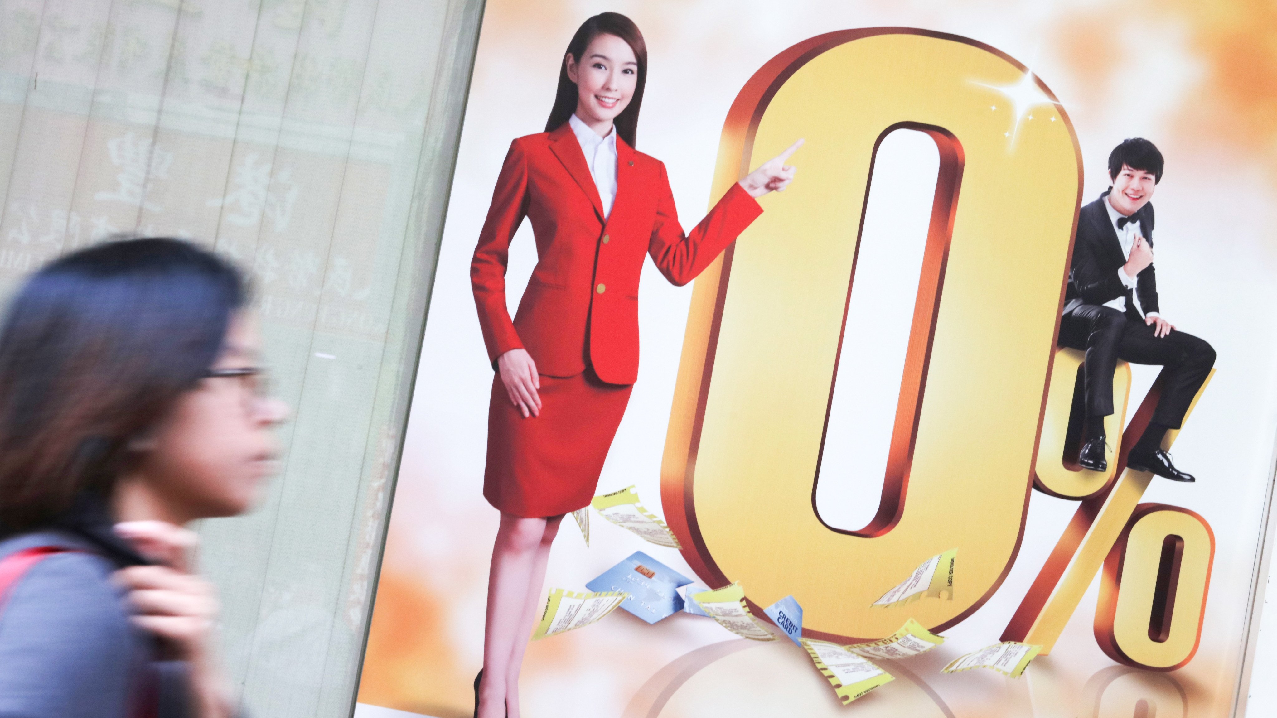 A pedestrian walks past a moneylending advertisement in Hong Kong. Photo: Felix Wong
