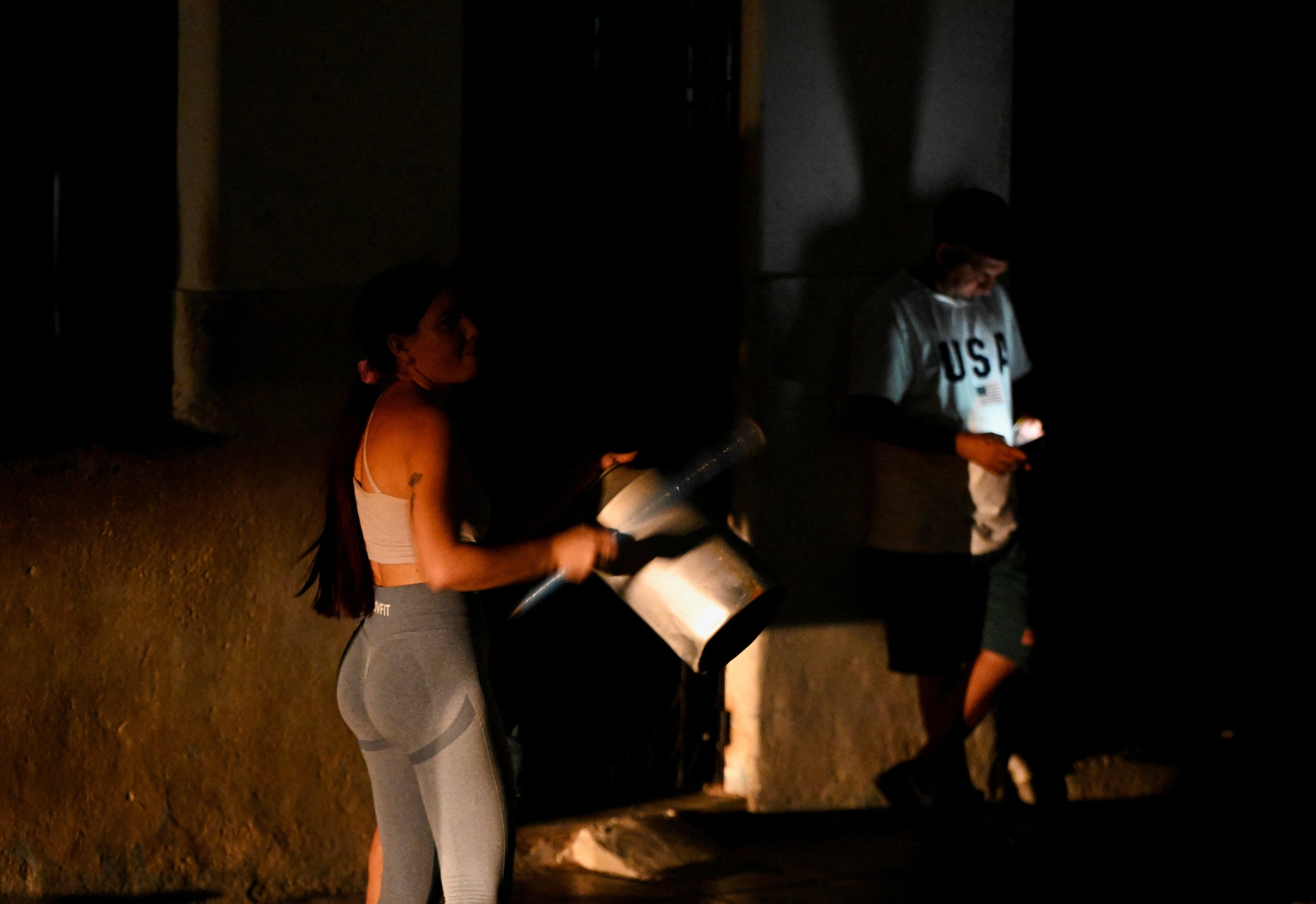 People bang pots and pans during a protest against electricity power cuts in Havana, Cuba, on March 7. Photo: Reuters
