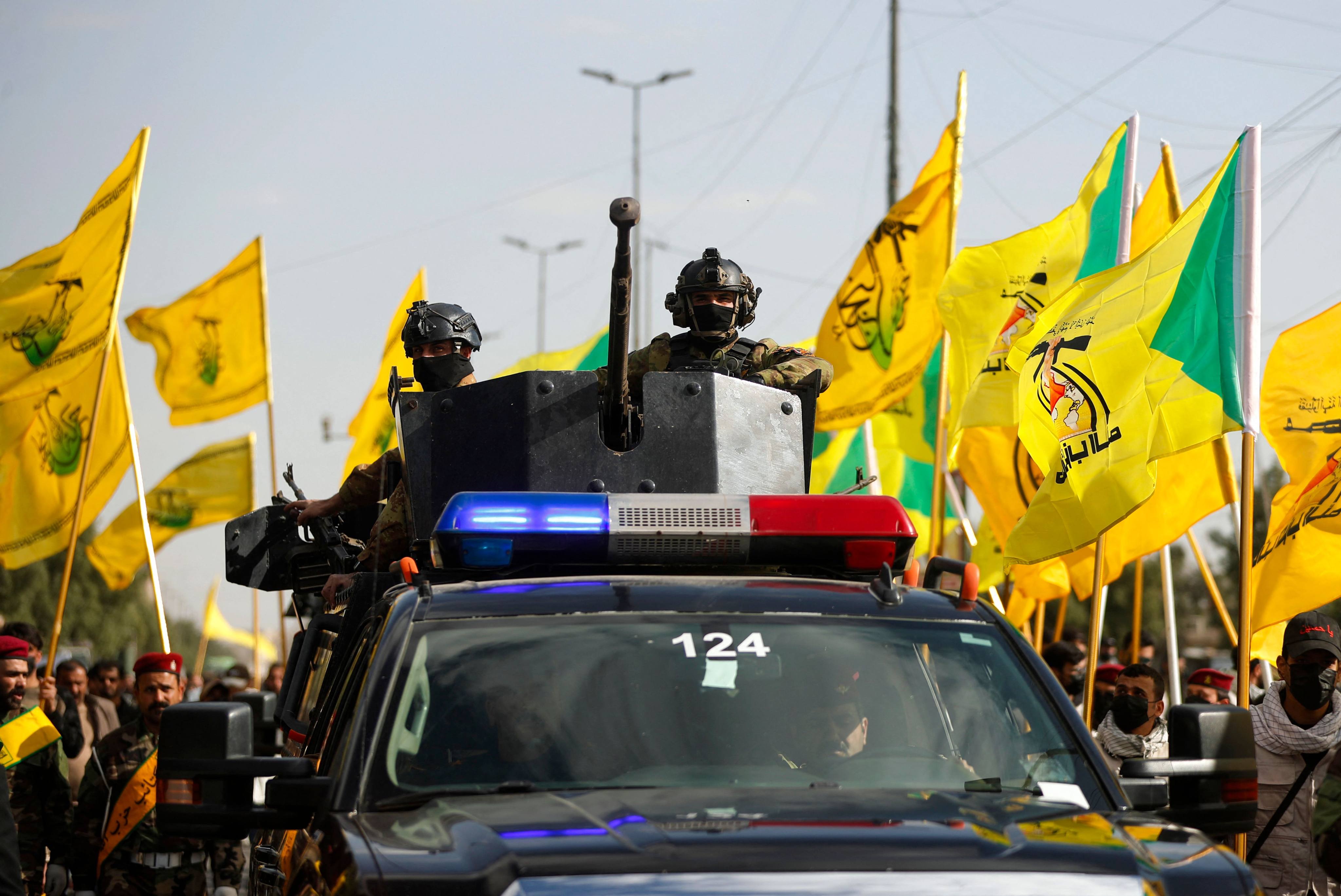 Iraqi security forces stand guard during the funeral procession of Kataeb Hezbollah members on March 5. Photo: AFP