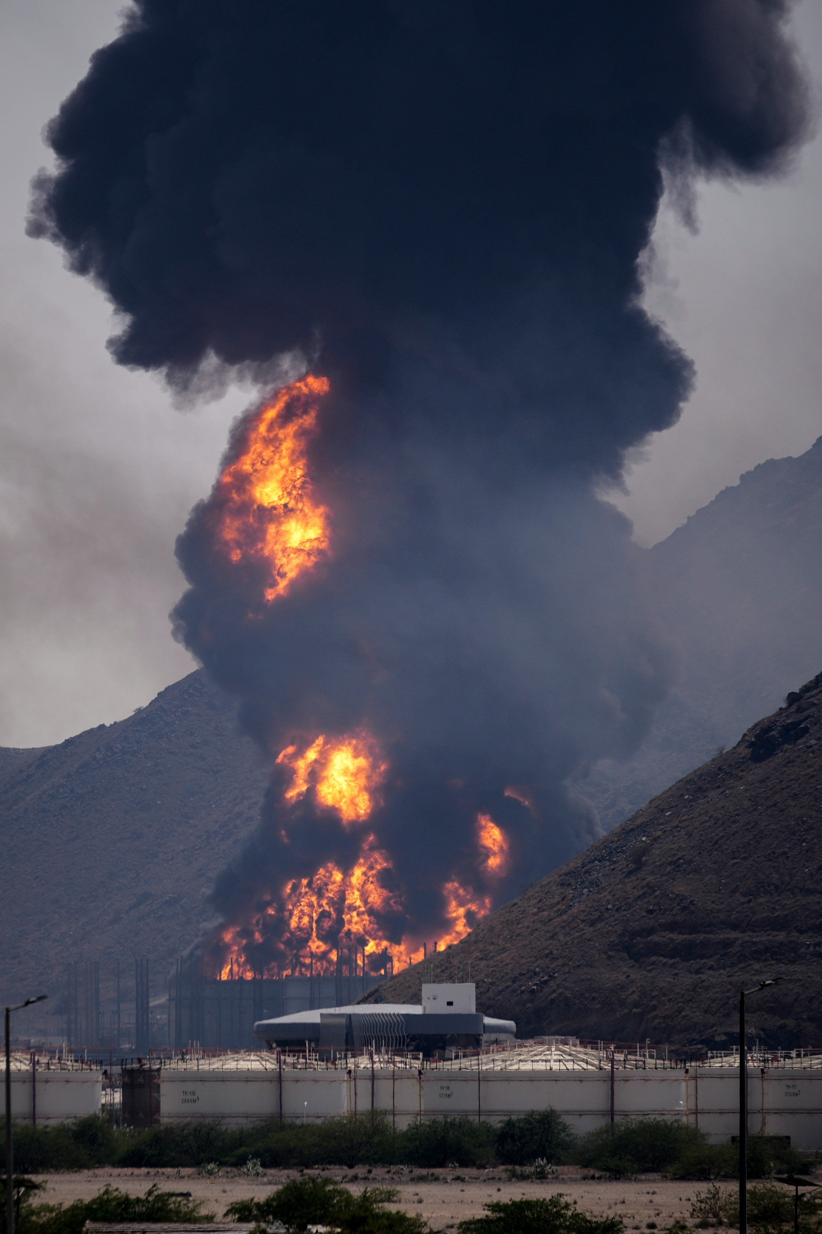 A fire and plume of smoke rise on Saturday after, authorities say, debris from an intercepted Iranian drone struck an oil facility in Fujairah in the United Arab Emirates. Photo: AP
