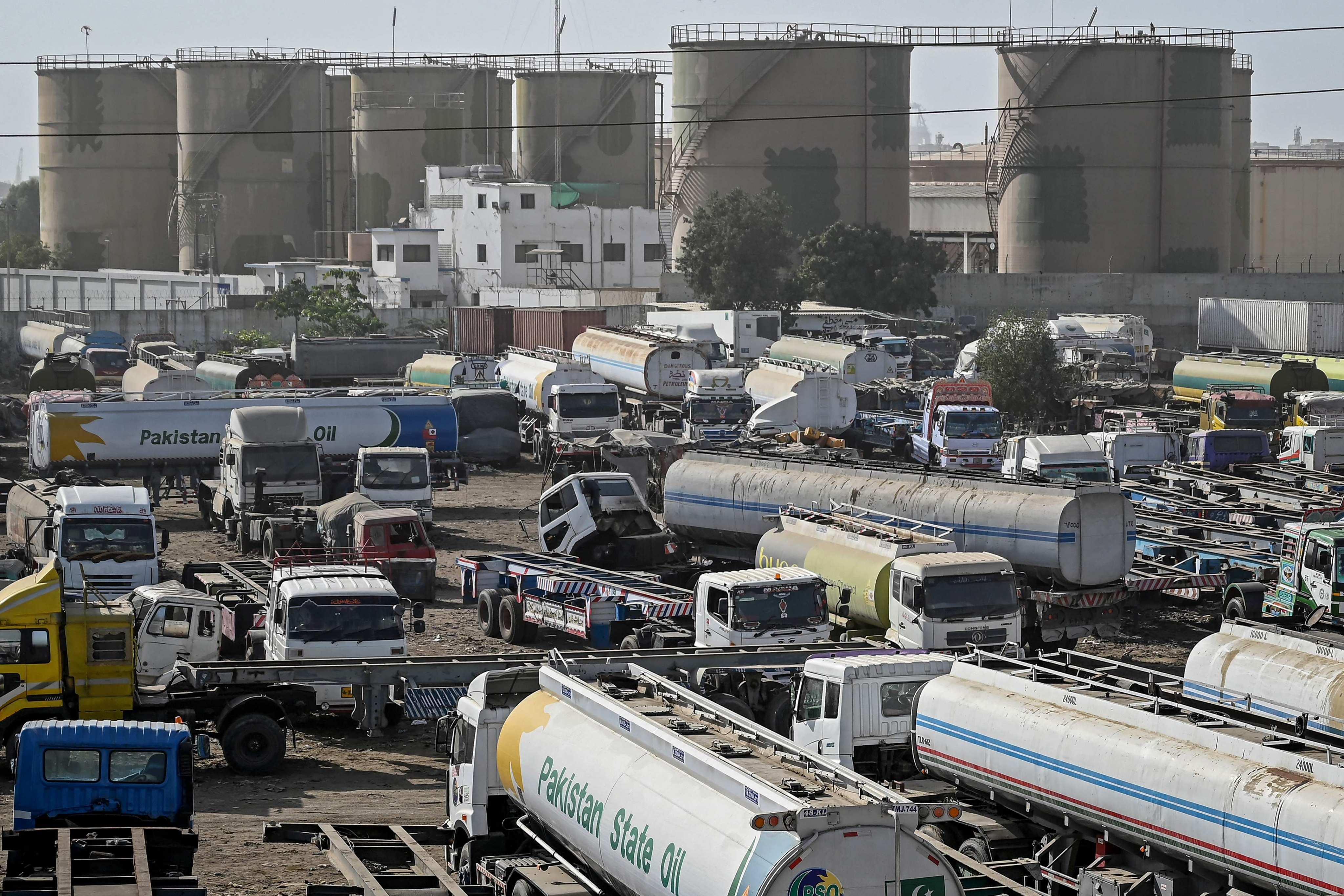 Oil tanker trucks stand parked near an oil storage terminal in Karachi on Thursday as global energy markets face disruptions amid ongoing conflict in the Middle East. Photo: AFP