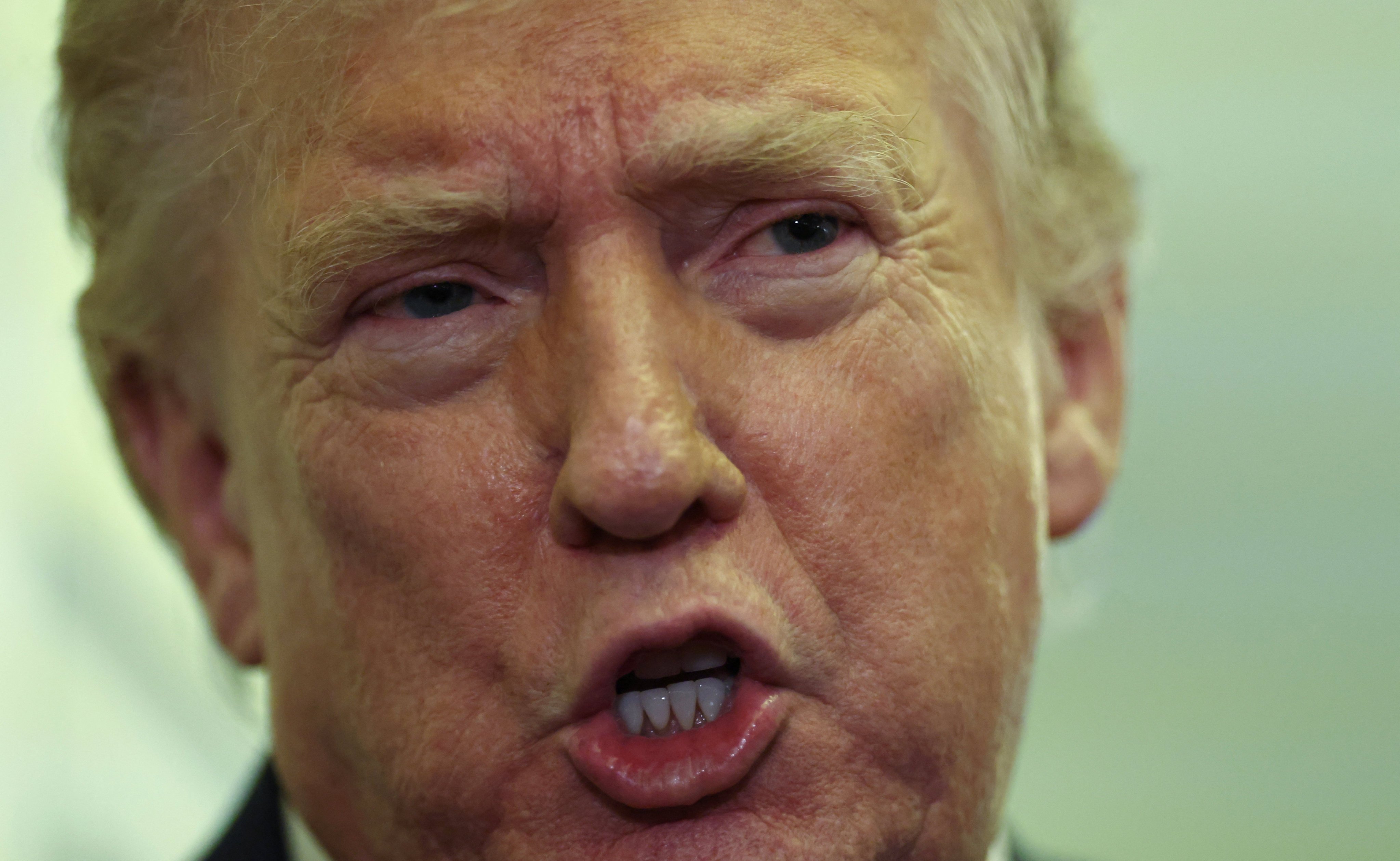US President Donald Trump speaks to reporters aboard Air Force One on a flight back to Washington on Sunday. Photo: Reuters