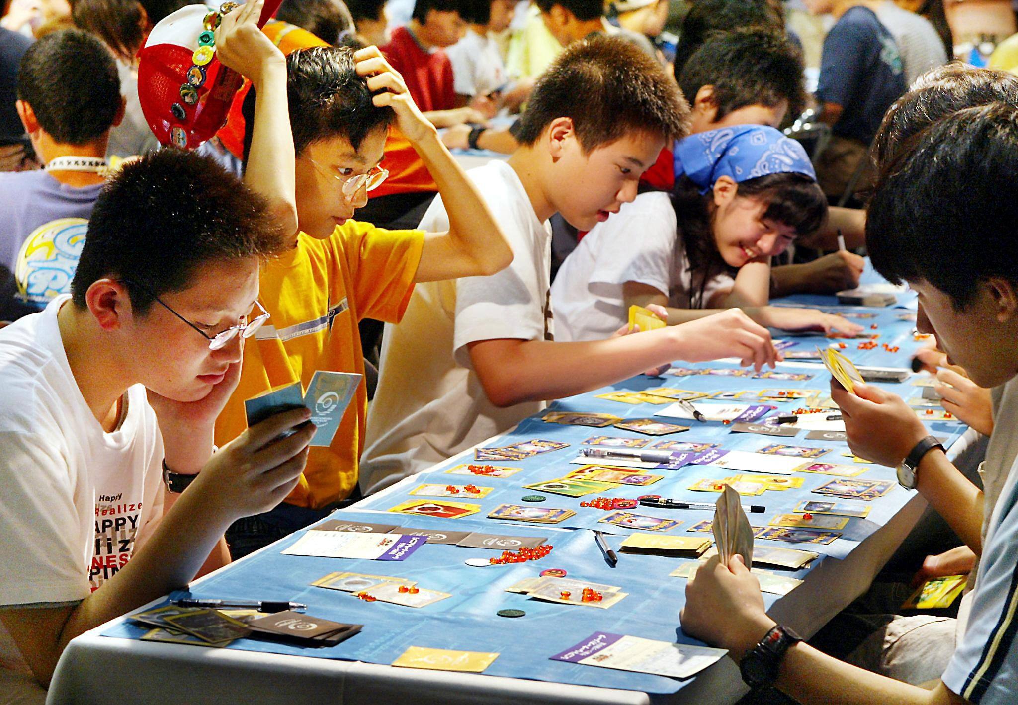 Japanese children play in a Pokemon (Pocket Monsters) card game tournament in Tokyo, on July 27, 2002. Photo: AFP