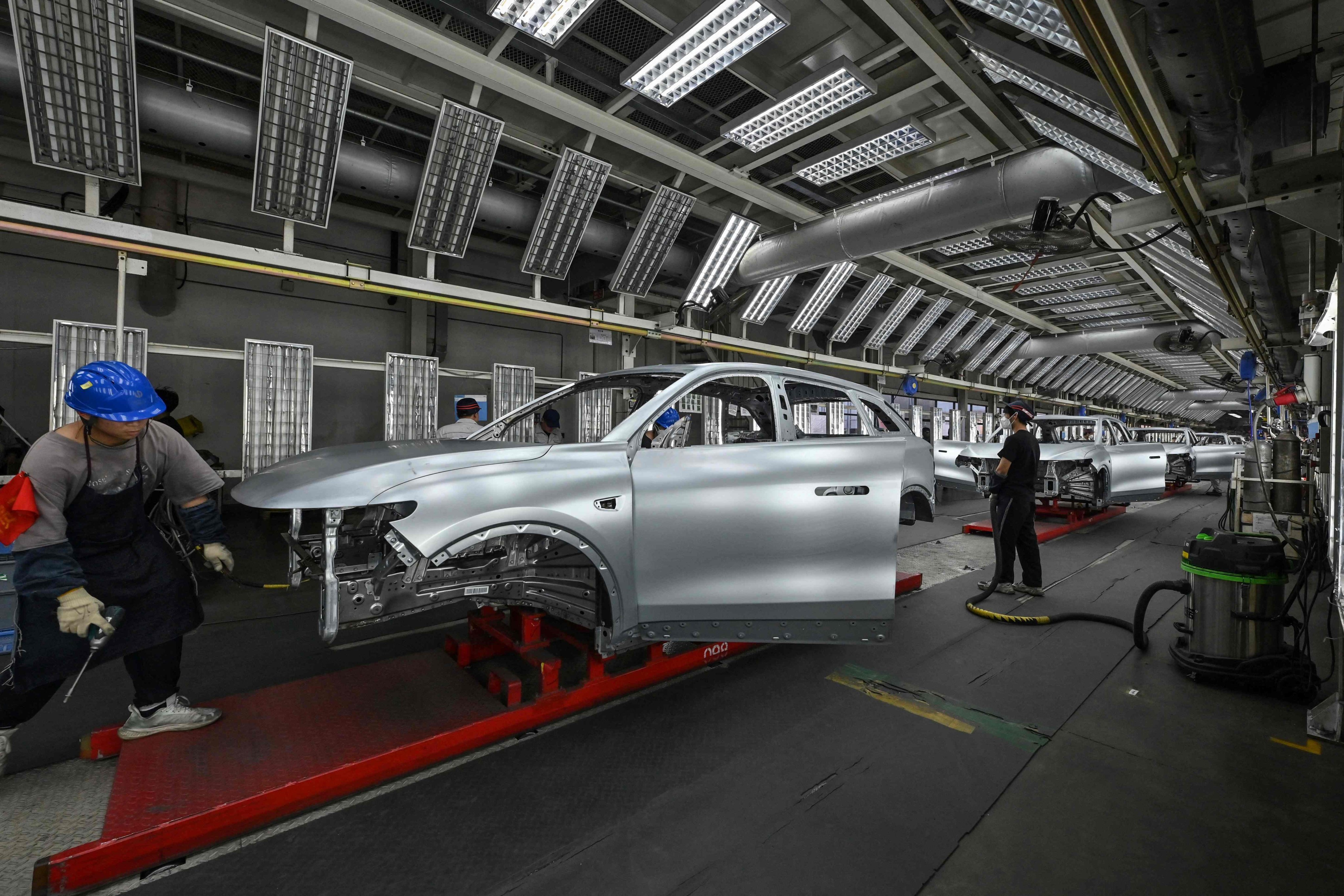 Employees work on an EV production line at the Leapmotor factory in Jinhua, Zhejiang province. Photo: AFP