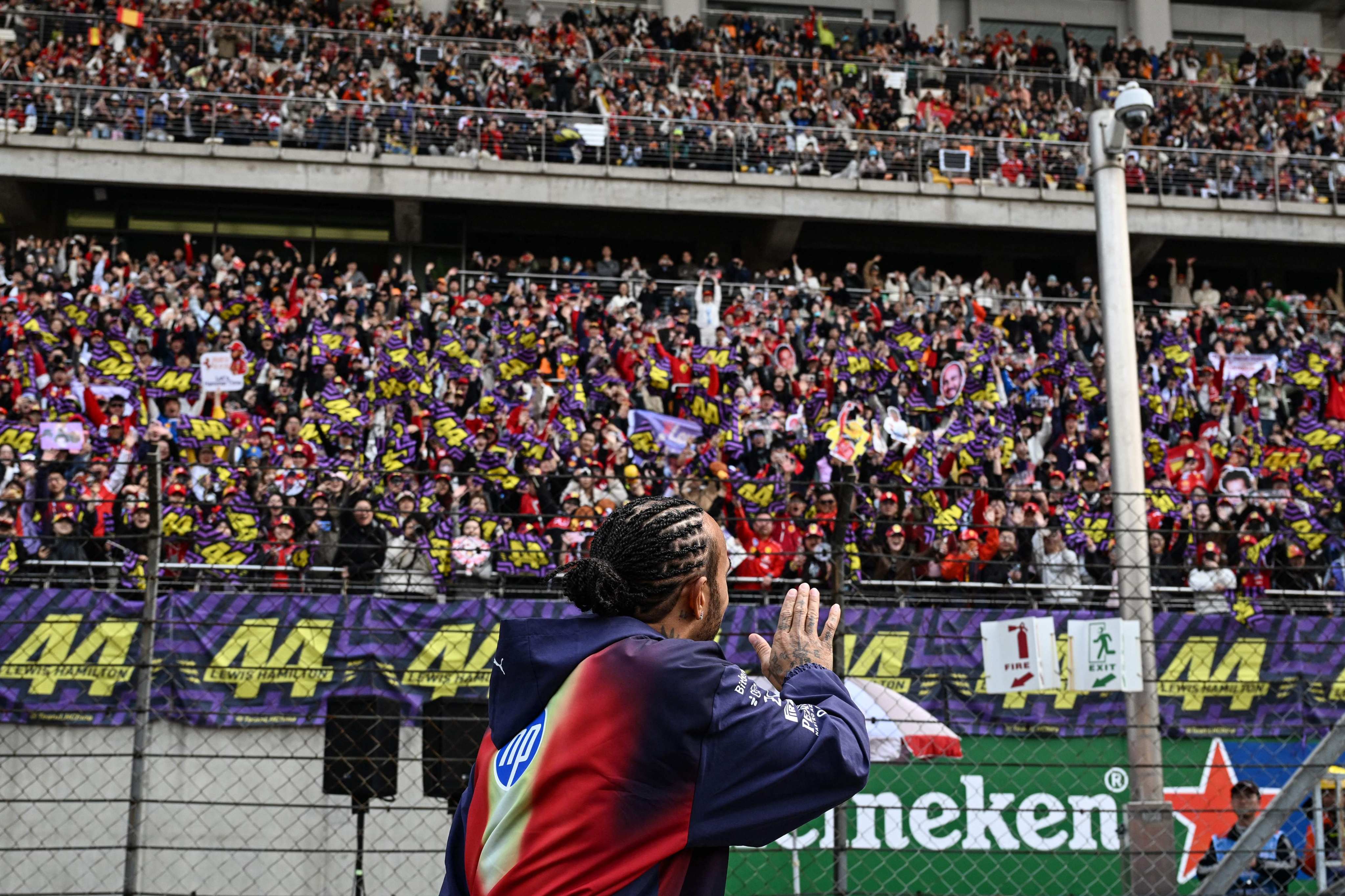 Ferrari’s British driver Lewis Hamilton greets his supporters prior to the Formula One Chinese Grand Prix at the Shanghai International Circuit. Photo: AFP