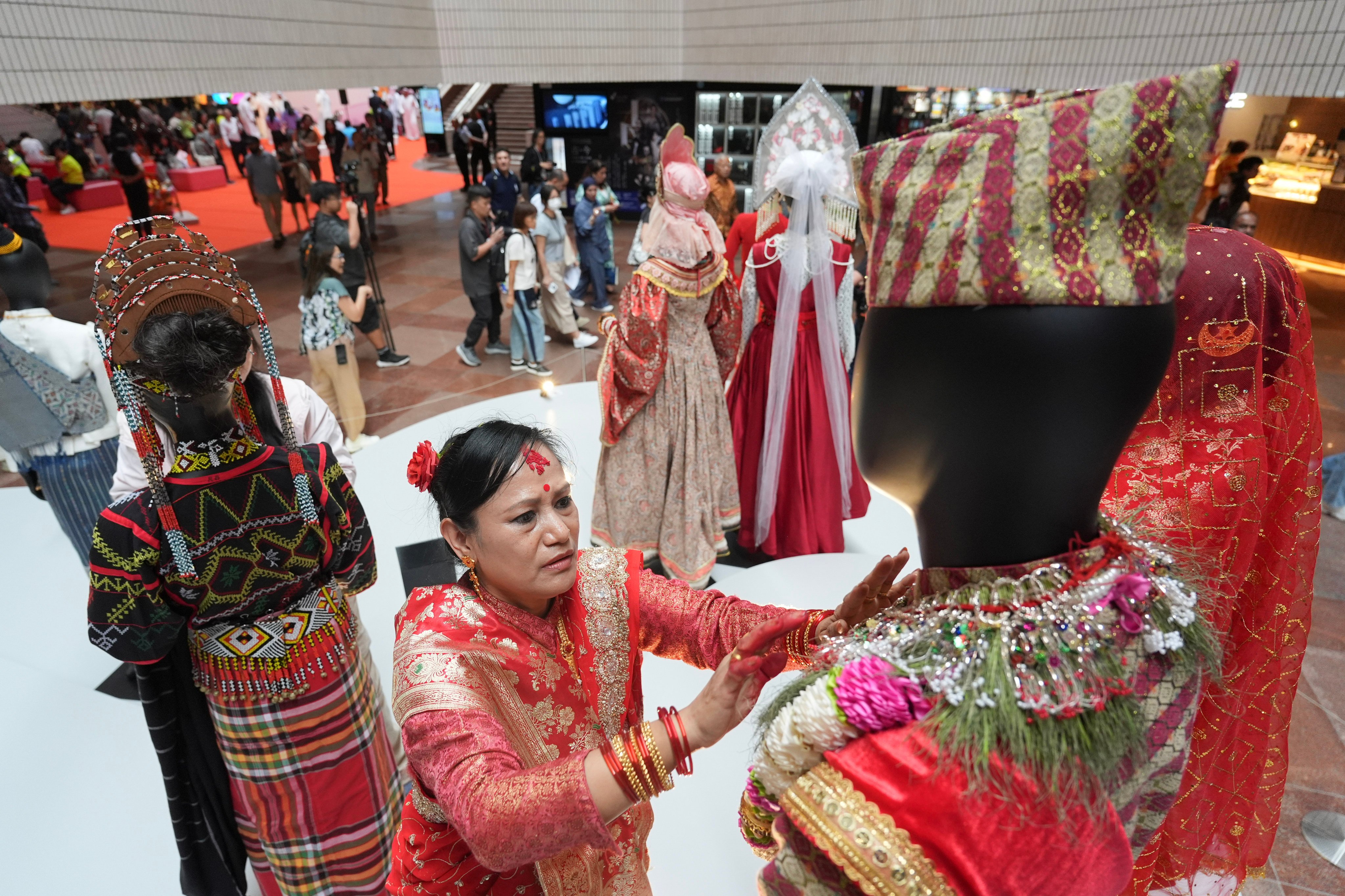A Nepali performer puts traditional costumes on a mannequin at the Asia+ Festival at the Hong Kong Cultural Centre in Tsim Sha Tsui on November 10, 2024. Photo: Eugene Lee
