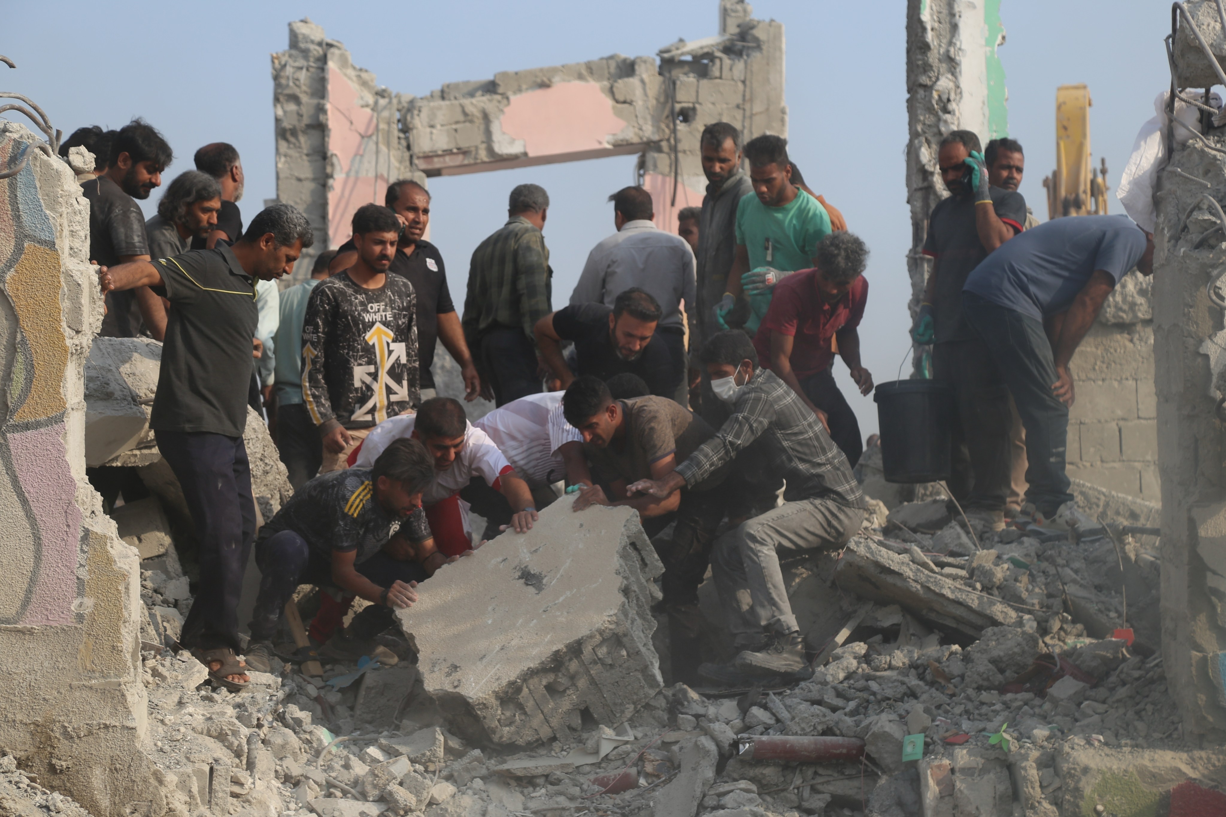 Rescuers search through the rubble after a girls’ school in Minab, Iran, is hit by a missile on February 28. Photo: AP