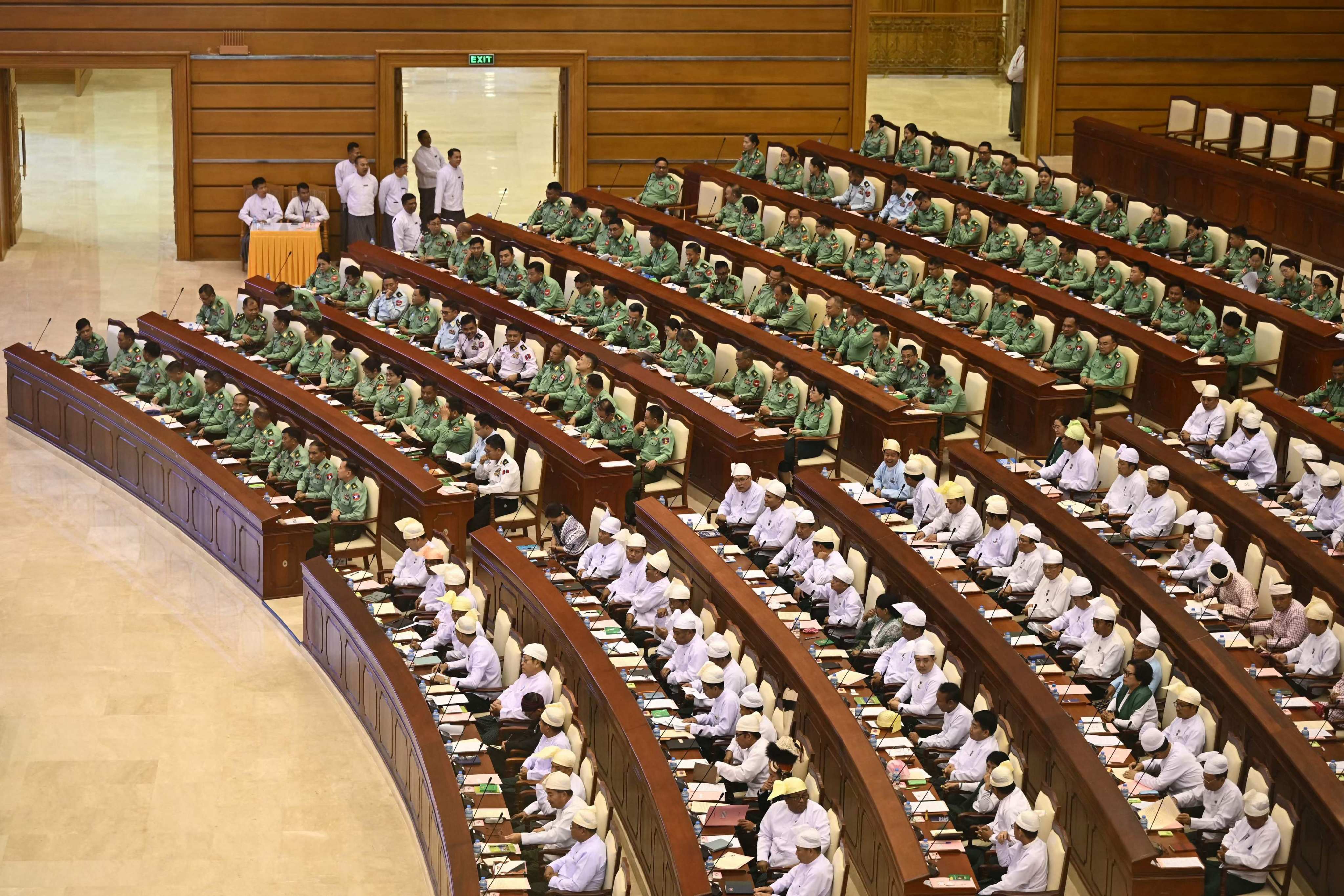 Military representatives (in green) and other members of Myanmar’s parliament attend a session in Naypyidaw on Monday. Photo: AFP