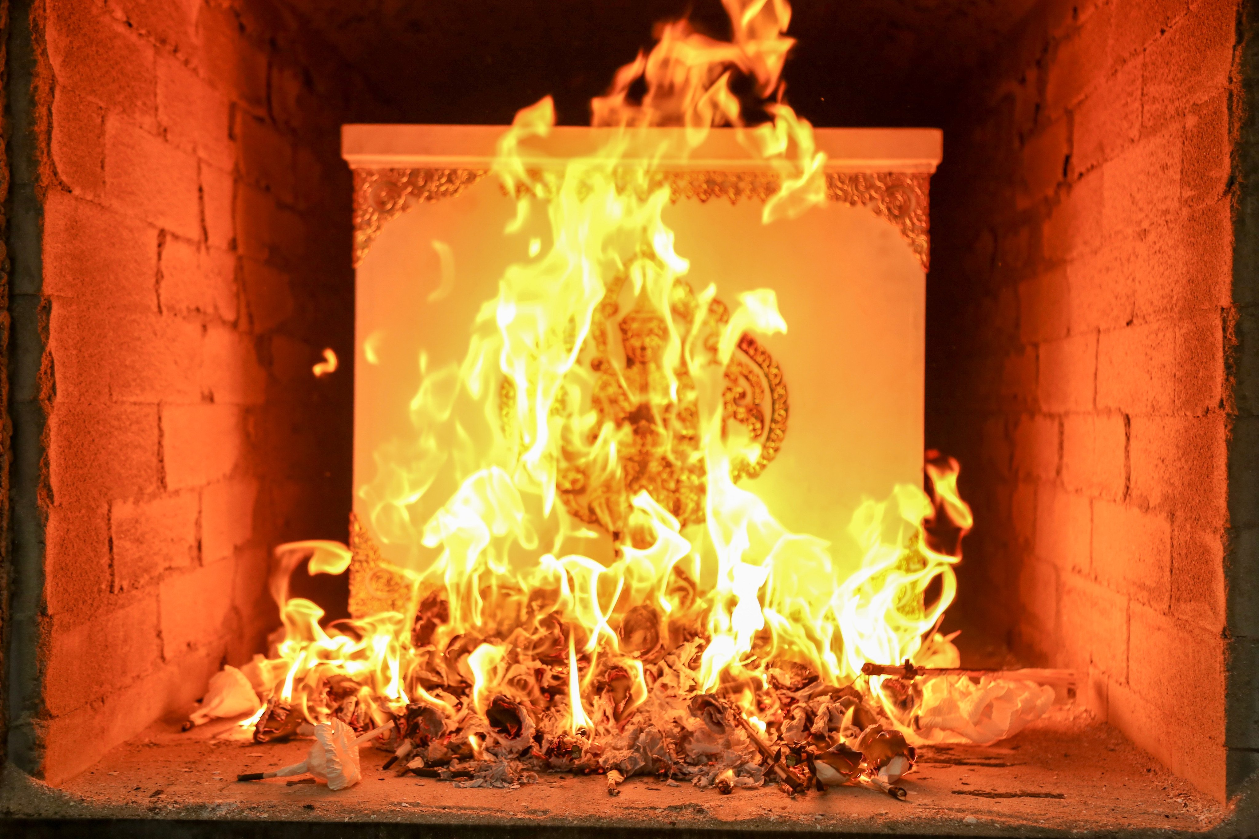 A coffin burns during a Thai cremation ceremony. Many crematoria in Thailand use diesel in their furnaces. Photo: Shutterstock