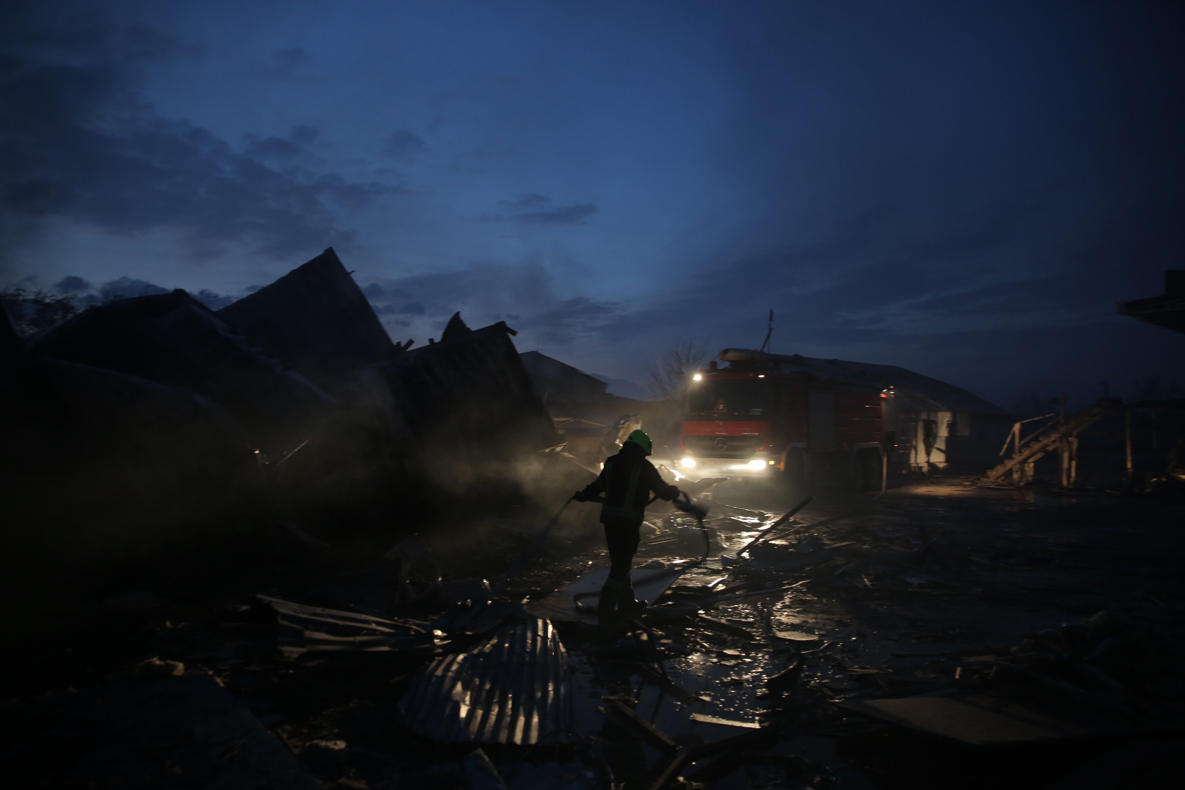 Firefighters work at the scene of alleged Pakistani air strikes in Kabul on Tuesday. Photo: EPA