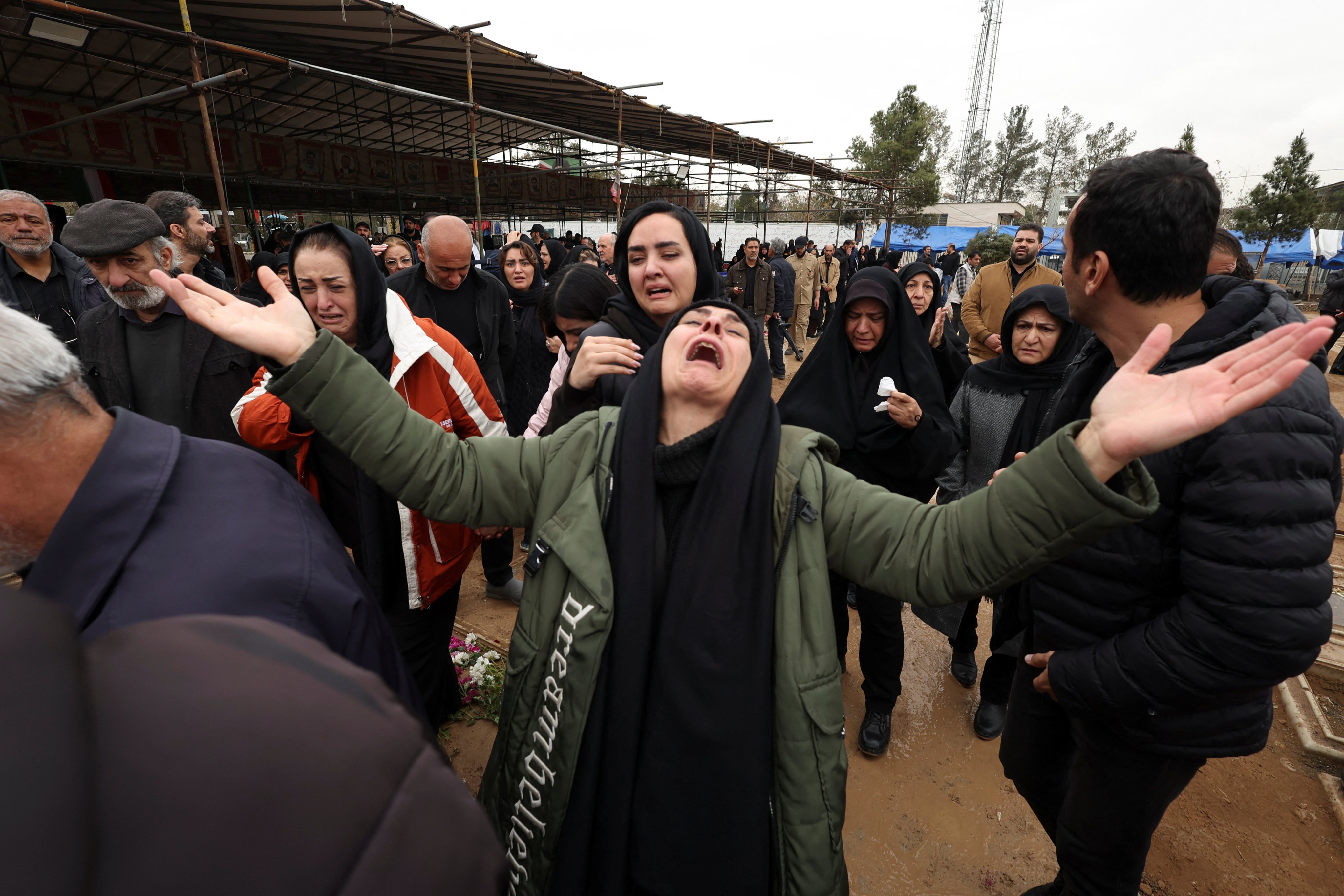 Relatives of Abdullah Pour Hossein, react during his funeral at Behesht-e Zahra cemetery, amid the U.S.-Israeli conflict with Iran, in Tehran, Iran, March 16, 2026. REUTERS/Alaa Al-Marjani