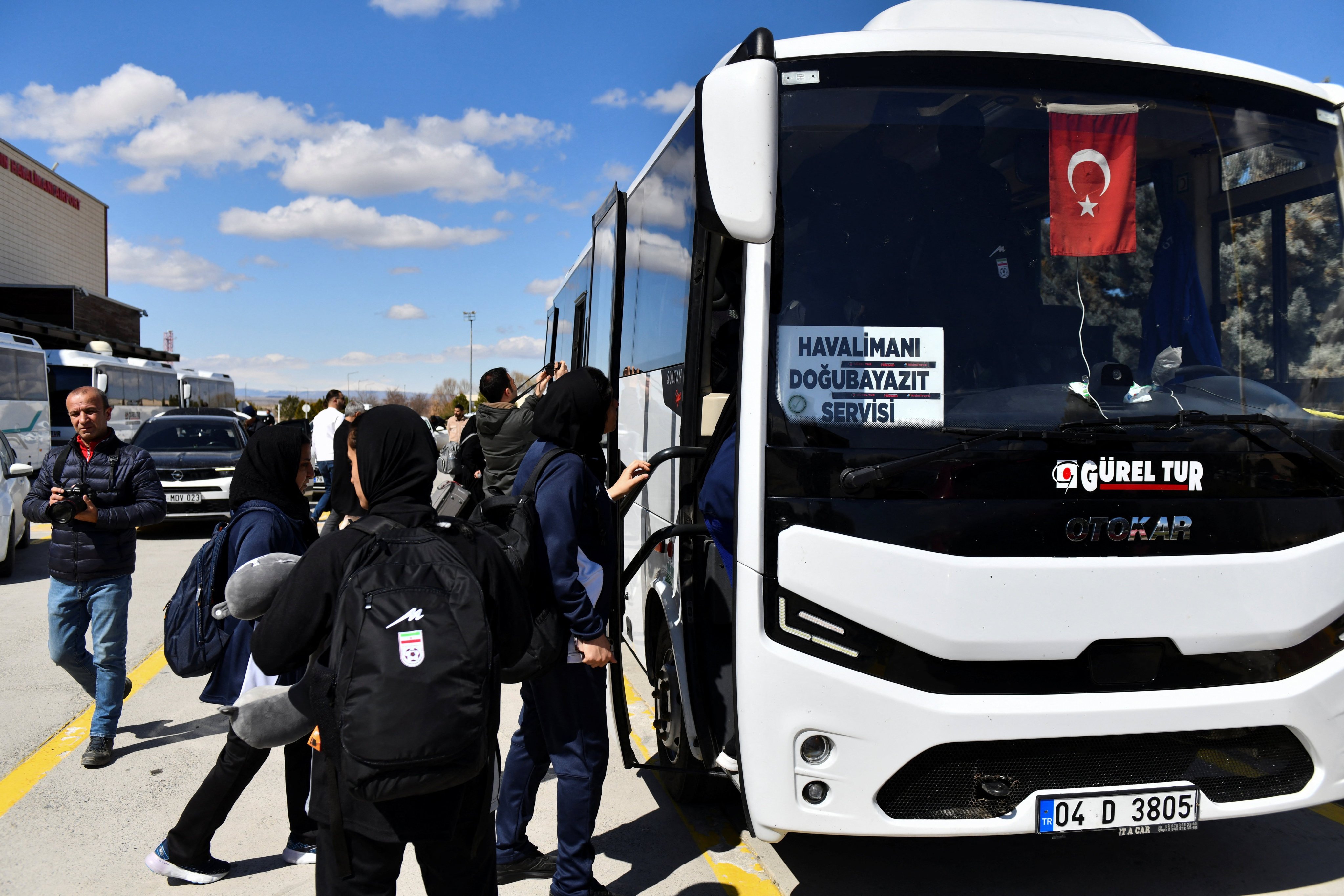 Members of the Iranian women’s national soccer team board a bus to the Turkish-Iranian border on Wednesday. Photo: Reuters
