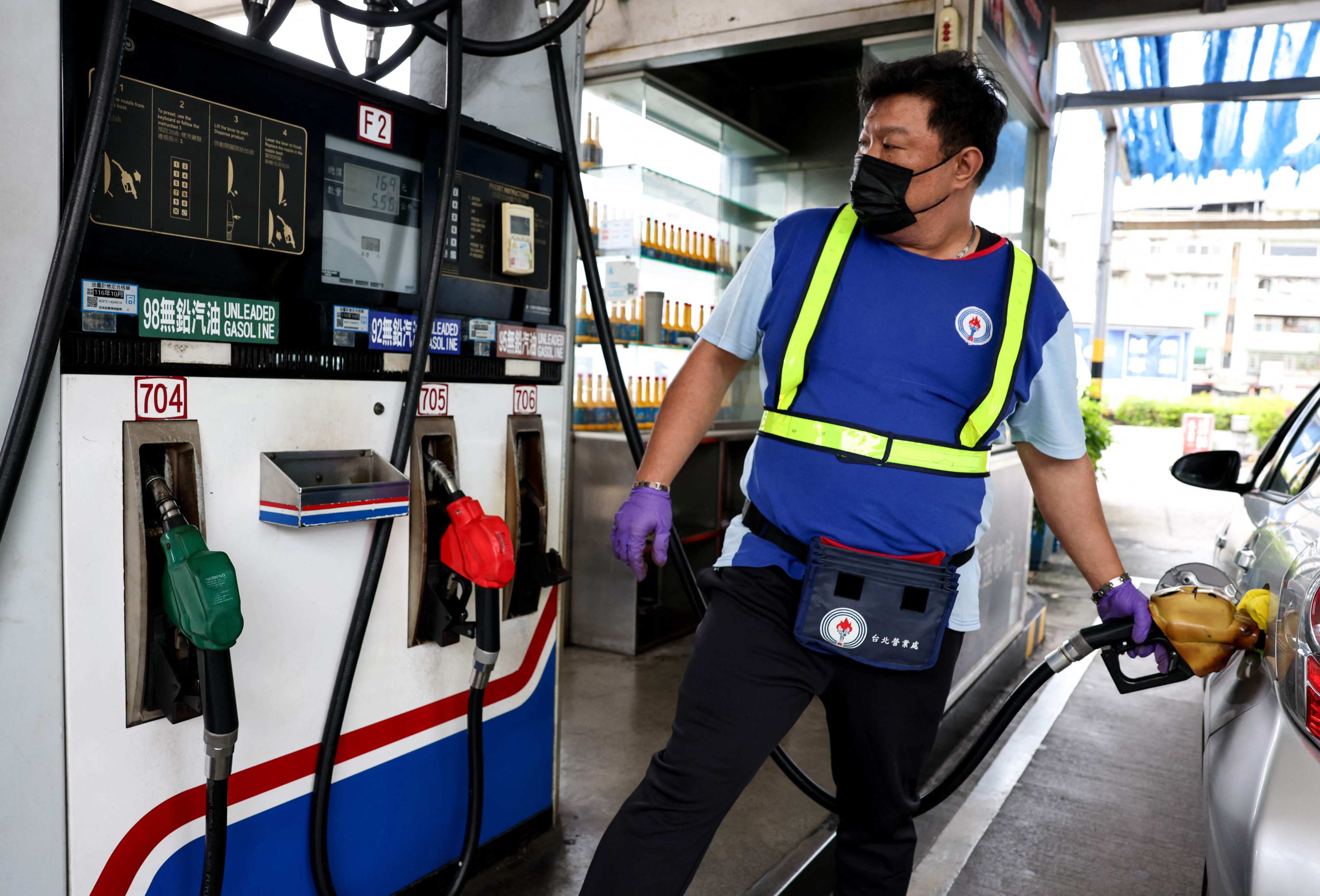 A petrol station worker refuels a car in Taipei on March 9. Photo: AFP