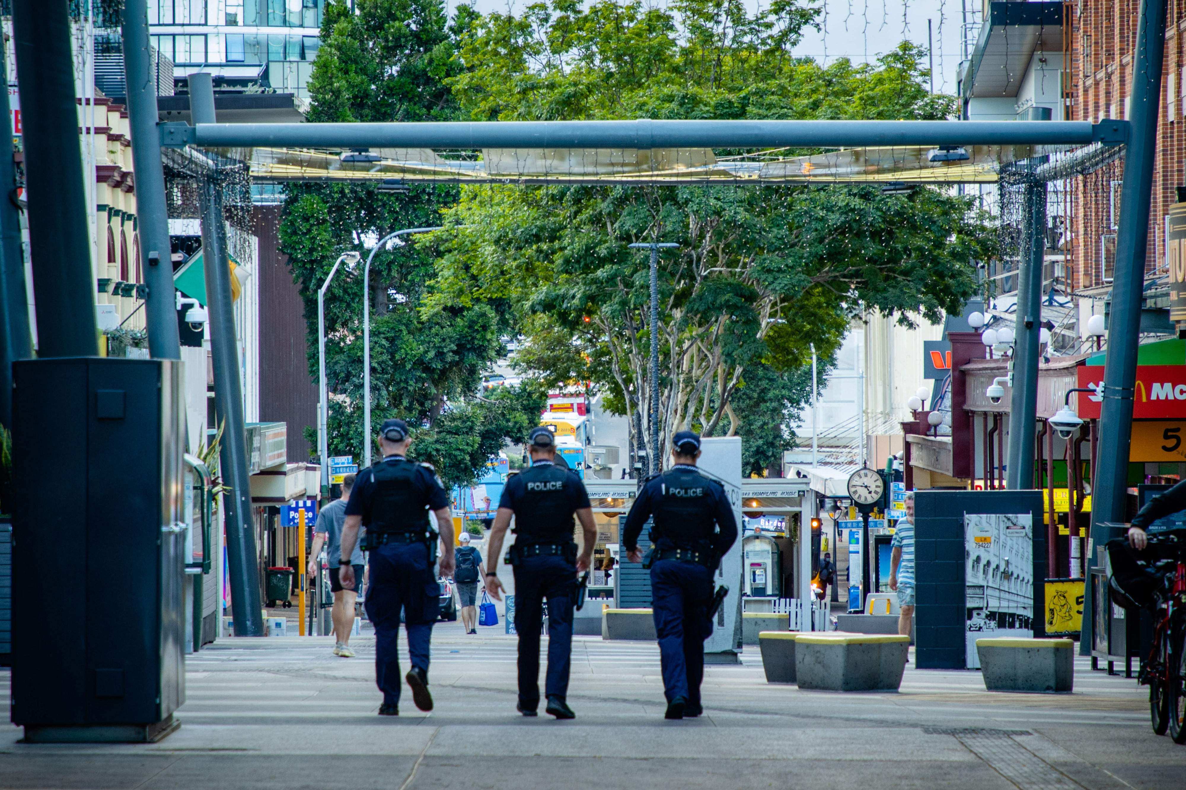 Police officers patrol the Valley Mall in Brisbane. Photo: AFP