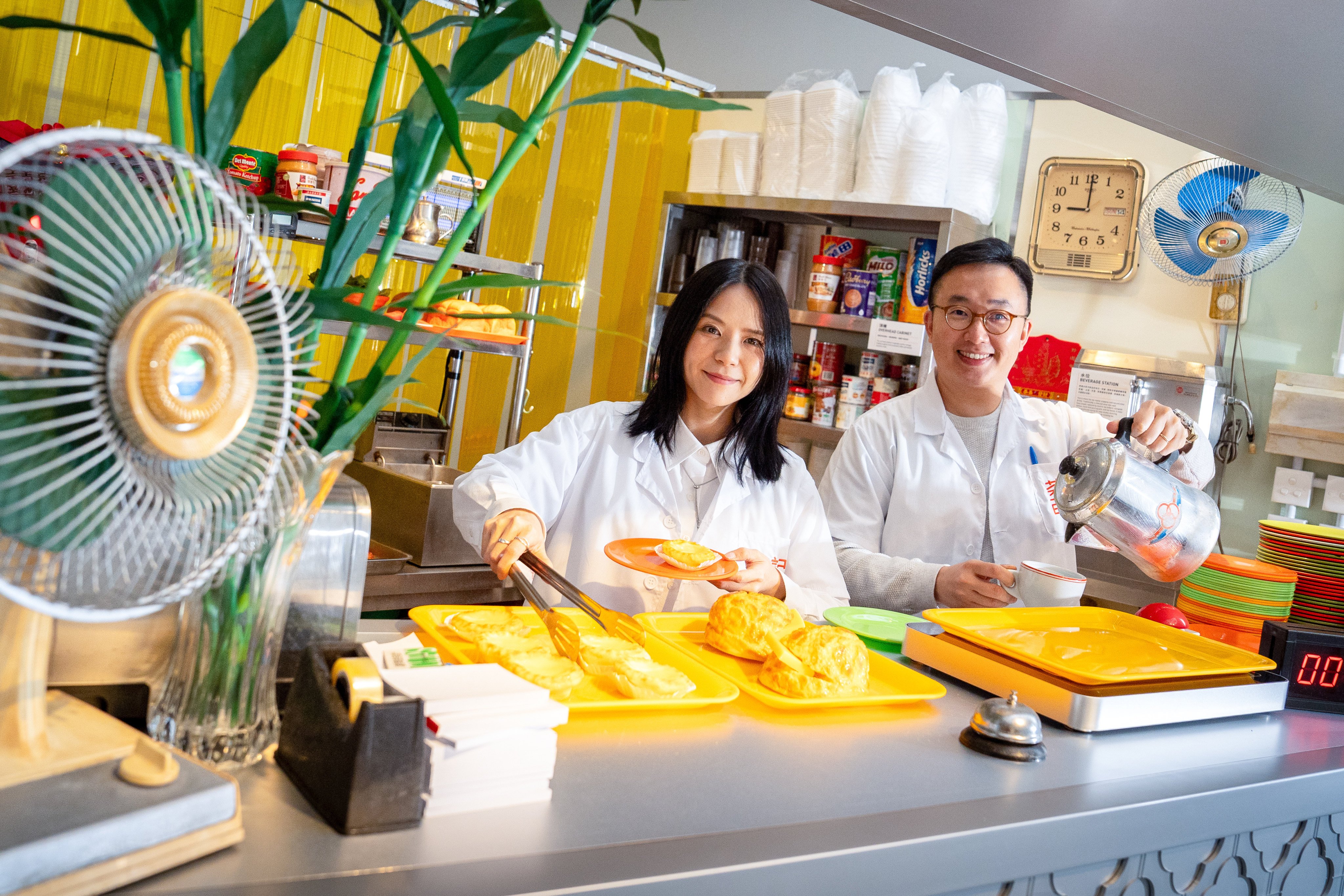 Kay Chan (left) and Charles Lai, curators of “The Cha Chaan Teng Codex — Tales of Invisible Designs”, are pictured at the exhibition at  Gate33 Gallery, in the Airside shopping centre, in Kai Tak, Hong Kong. Photo: Elson Li