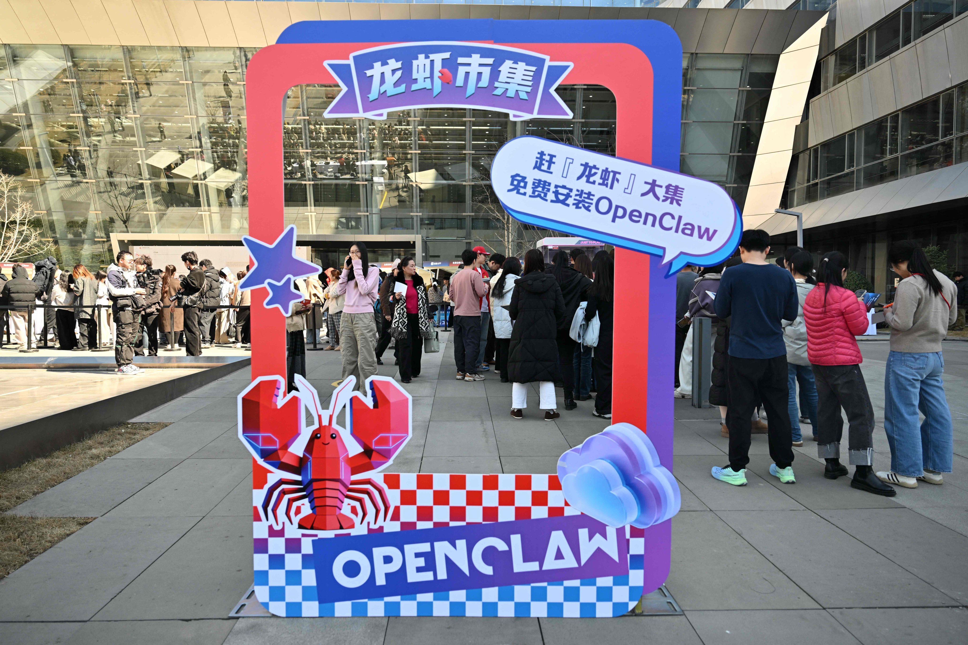 People queue to have OpenClaw, an open-source AI assistant, installed on their devices, at Baidu’s headquarters in Beijing on March 11. Photo: AFP