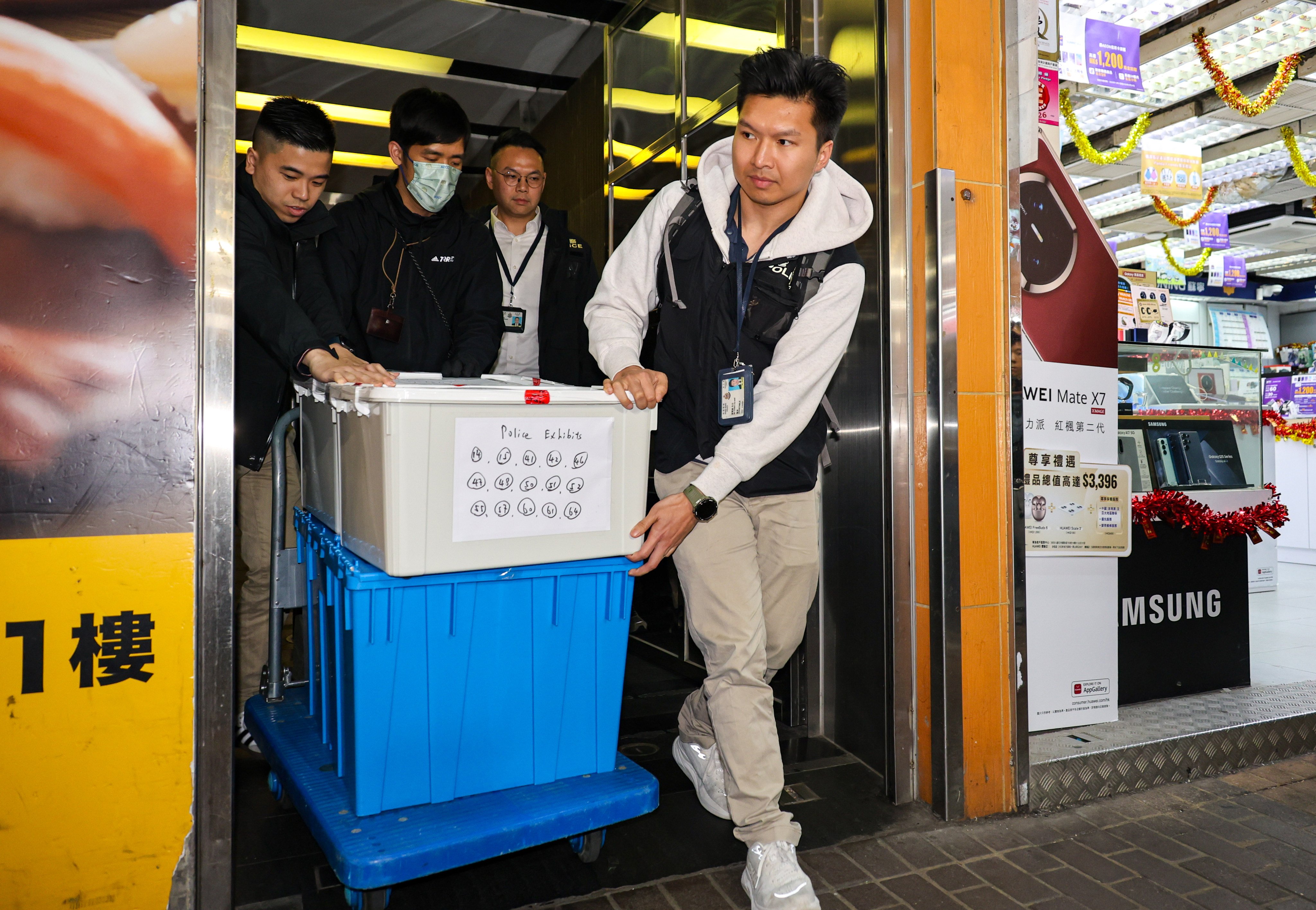Police take away boxes from a law firm in Mong Kok during an operation last month. Photo: Handout