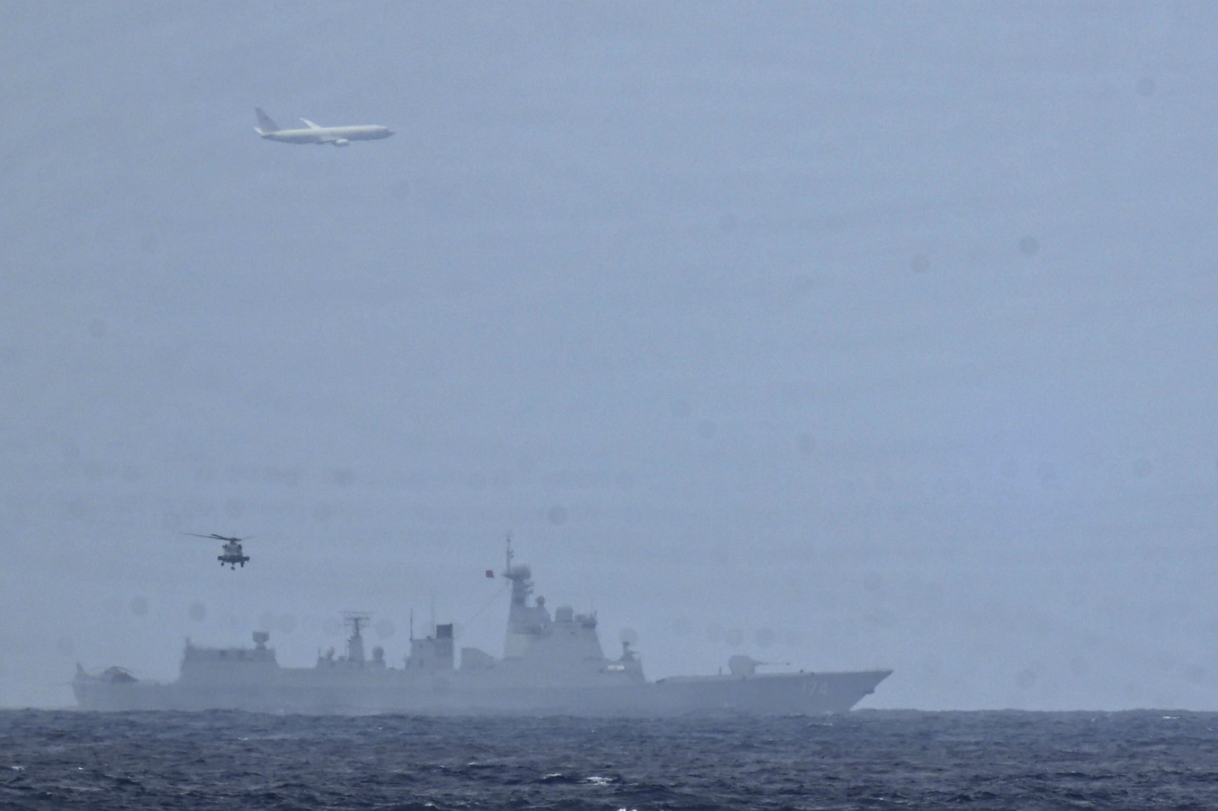 US military aircraft fly near the Bashi Channel between the Philippines and Taiwan with a Chinese naval vessel seen in the distance in February. Photo: Kyodo