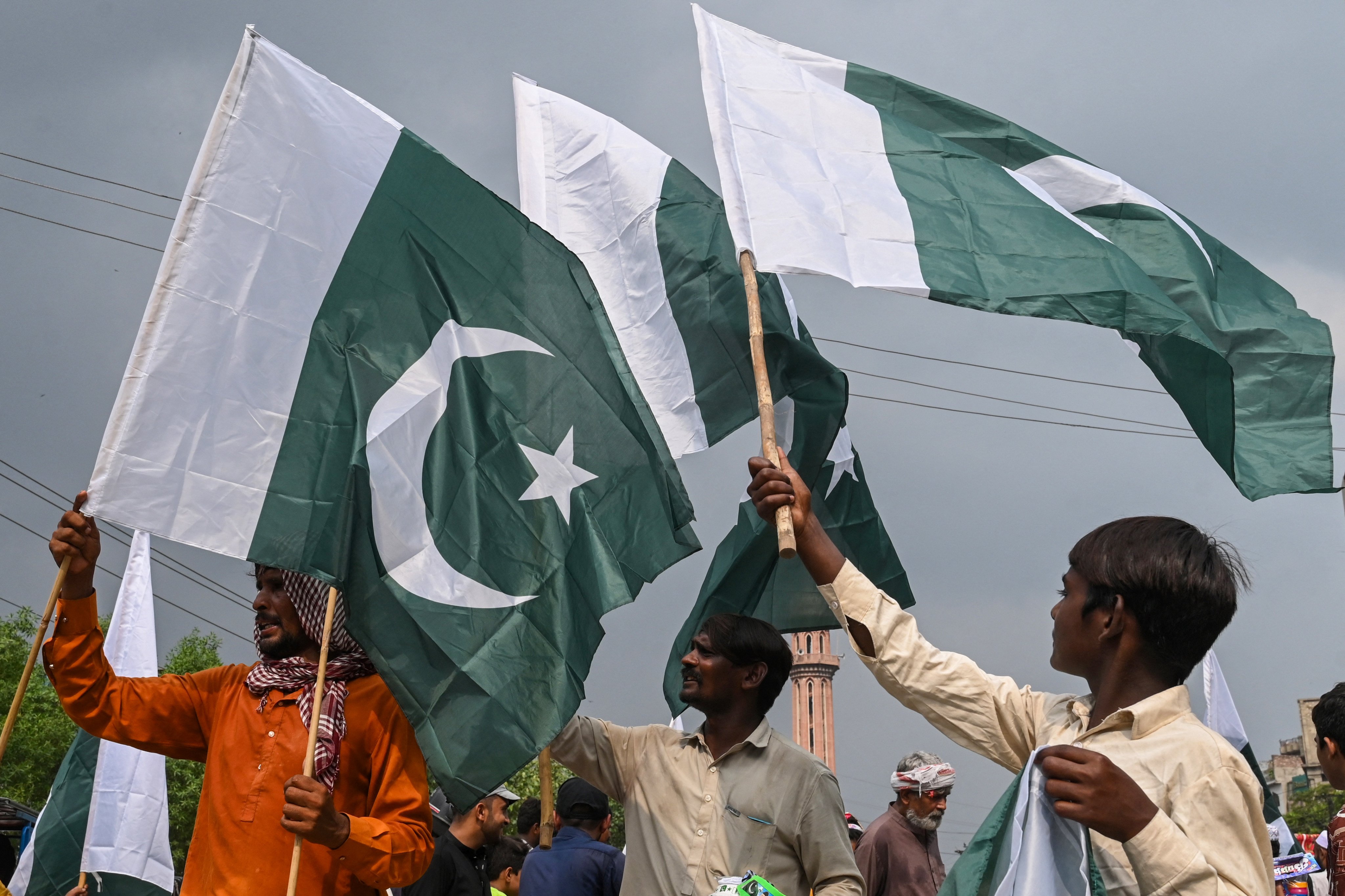 Hawkers selling toys and decorative items display Pakistan’s national flags at a market ahead of country’s Independence Day celebrations, in Lahore on August 10, 2025. (Photo by Arif ALI / AFP)