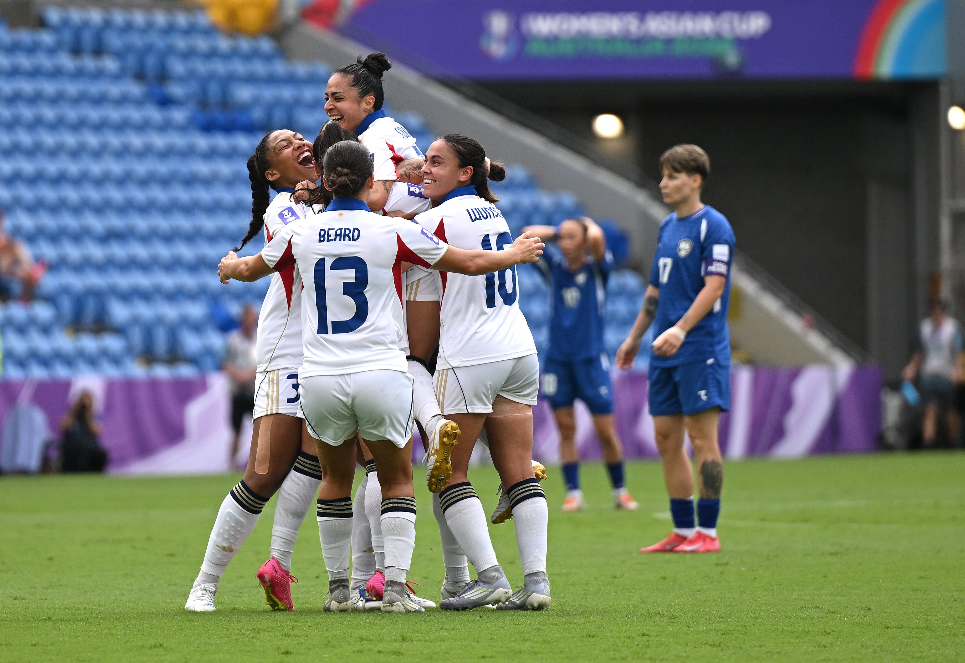 Jaclyn Sawicki (centre)  celebrates after scoring the Philippines’ second against Uzbekistan in the Gold Coast. Photo: EPA