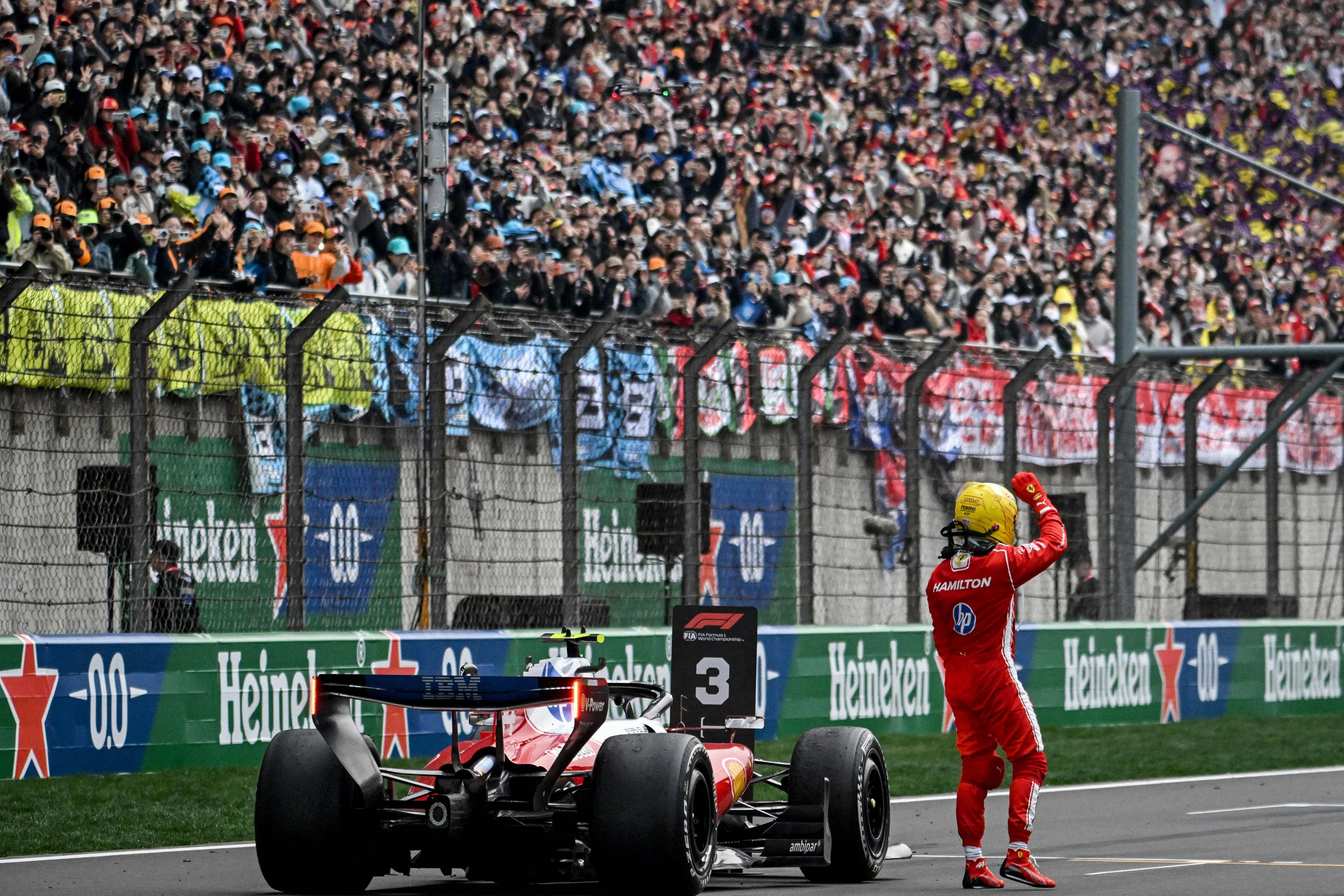 Ferrari’s British driver Lewis Hamilton waves to the fans after the Formula One Chinese Grand Prix at the Shanghai International Circuit in Shanghai on March 15. Photo: AFP