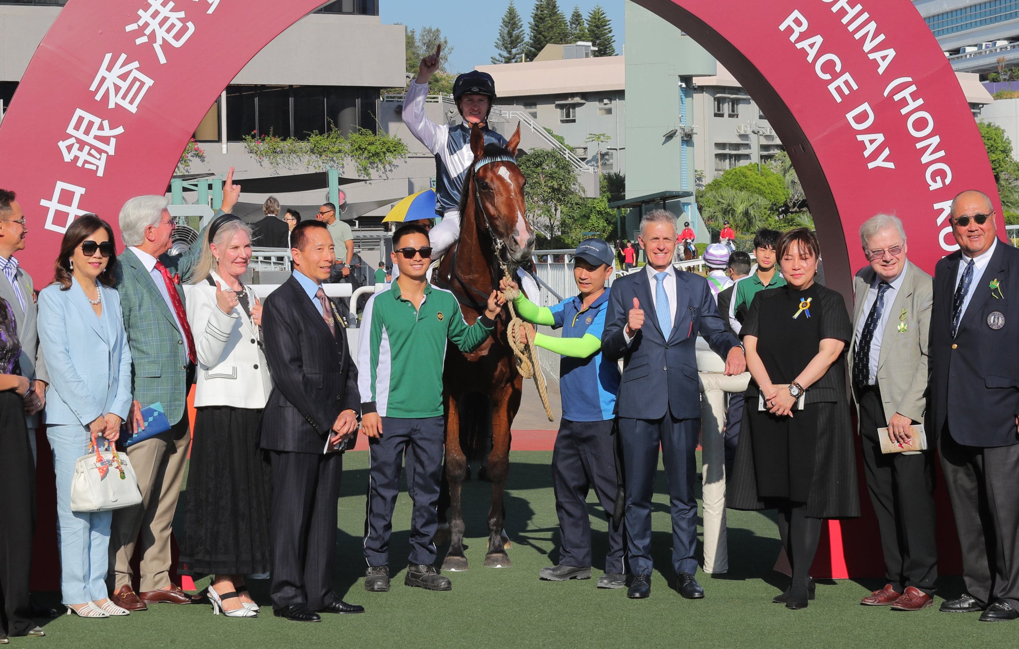 Nick Etches (second from eight) and connections with Invincible Ibis after his Sha Tin triumph in November.