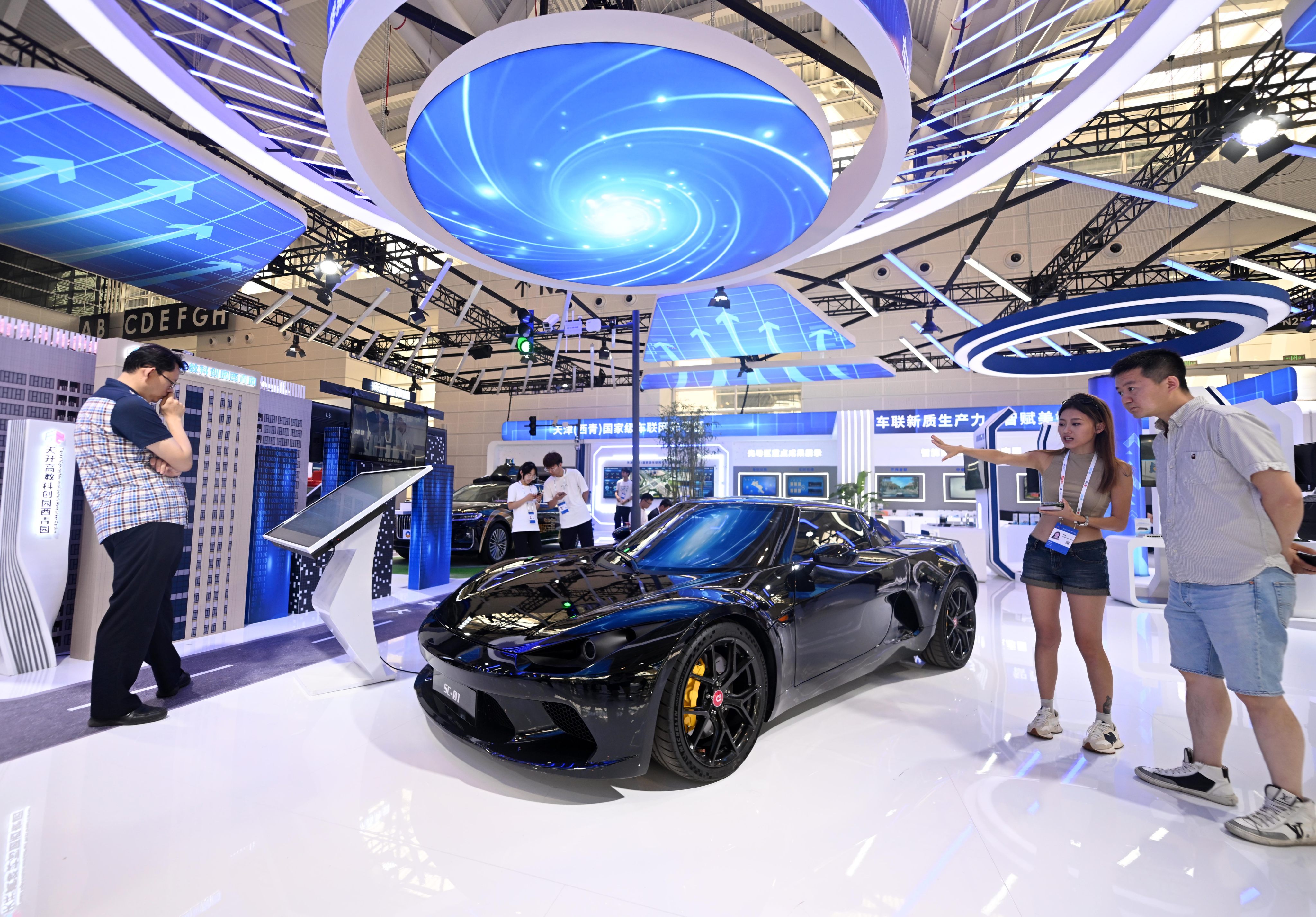 Visitors look at a new-energy sports car at an expo in Tianjin. Photo: Xinhua