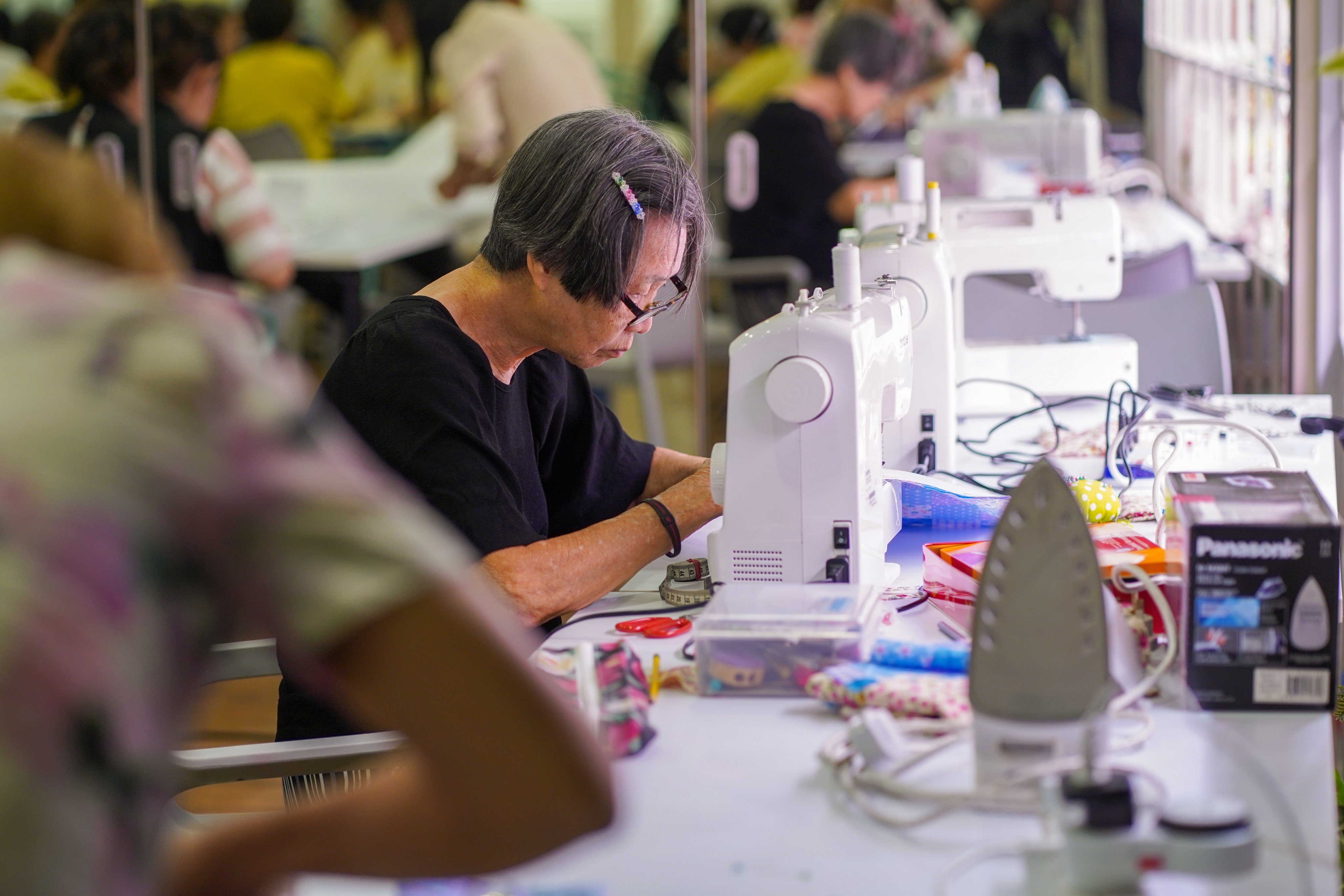 Elderly citizens use sewing machines at the Yong-en Active Hub in Singapore. Photo: Kolette Lim