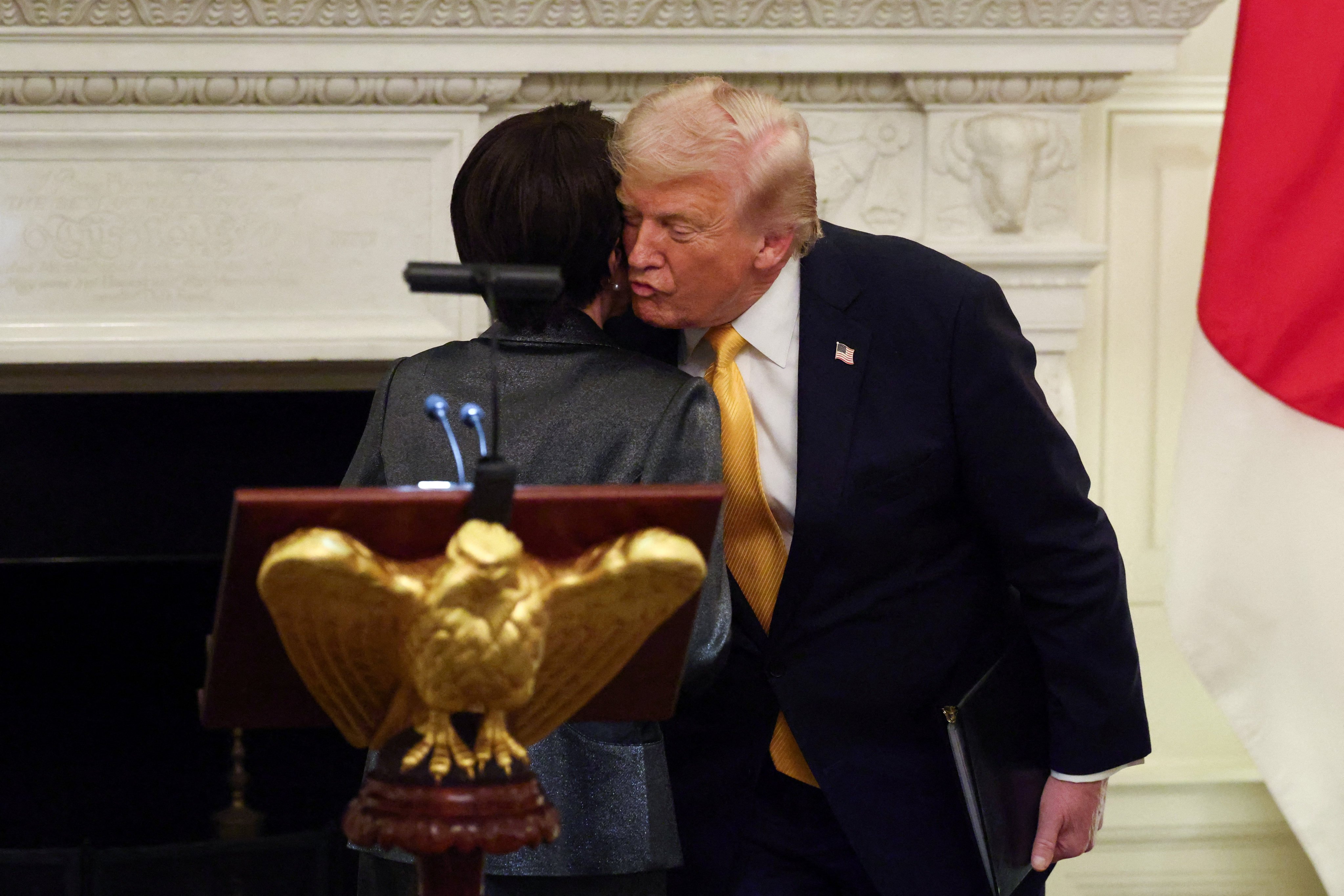 US President Donald Trump kisses Japanese Prime Minister Sanae Takaichi during a dinner at the White House on Thursday. Photo: Reuters