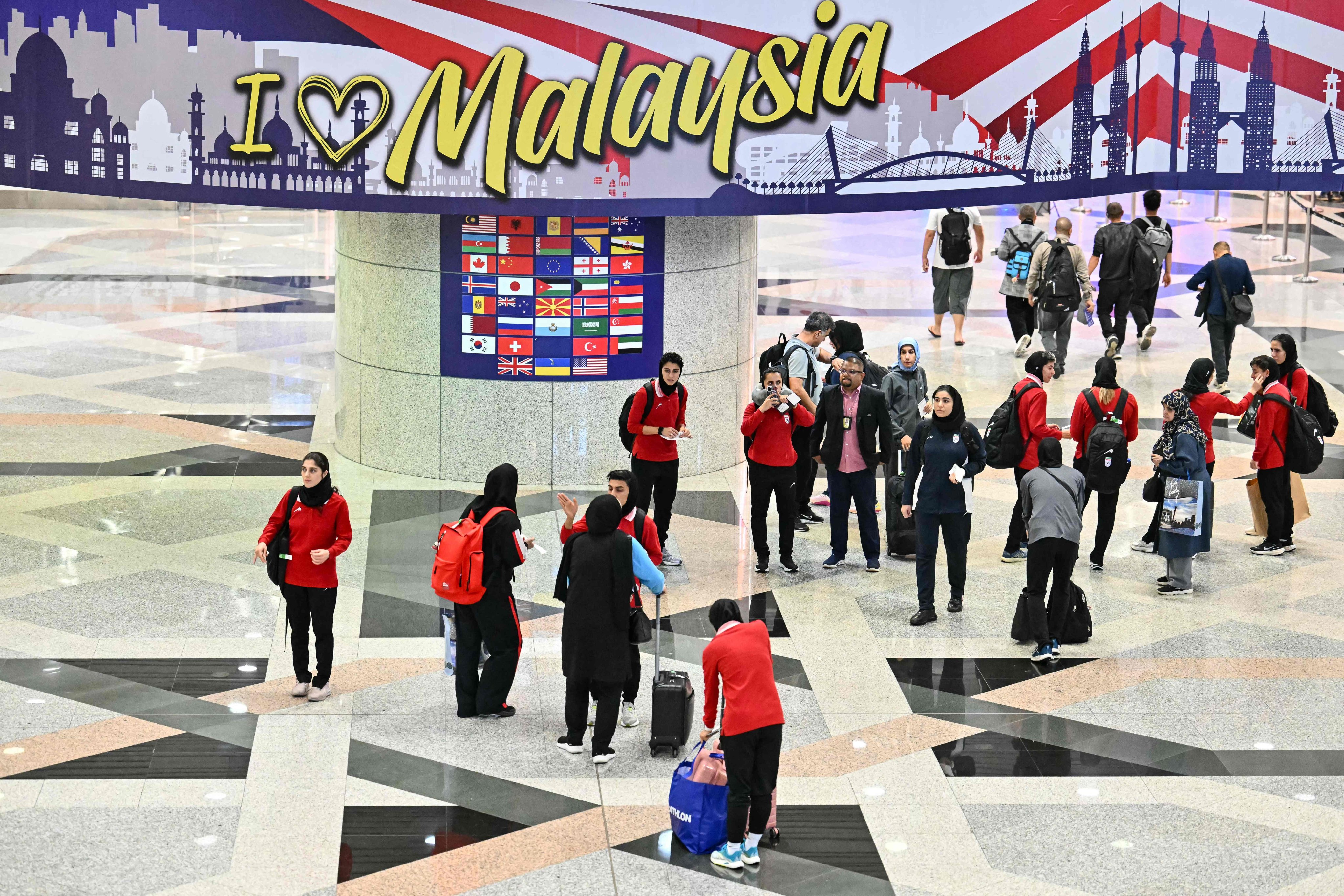 Members of the Iranian women’s football team seen at Kuala Lumpur International Airport on Monday after staying in a hotel in the Malaysian capital while awaiting the next leg of their journey home. Photo: AFP