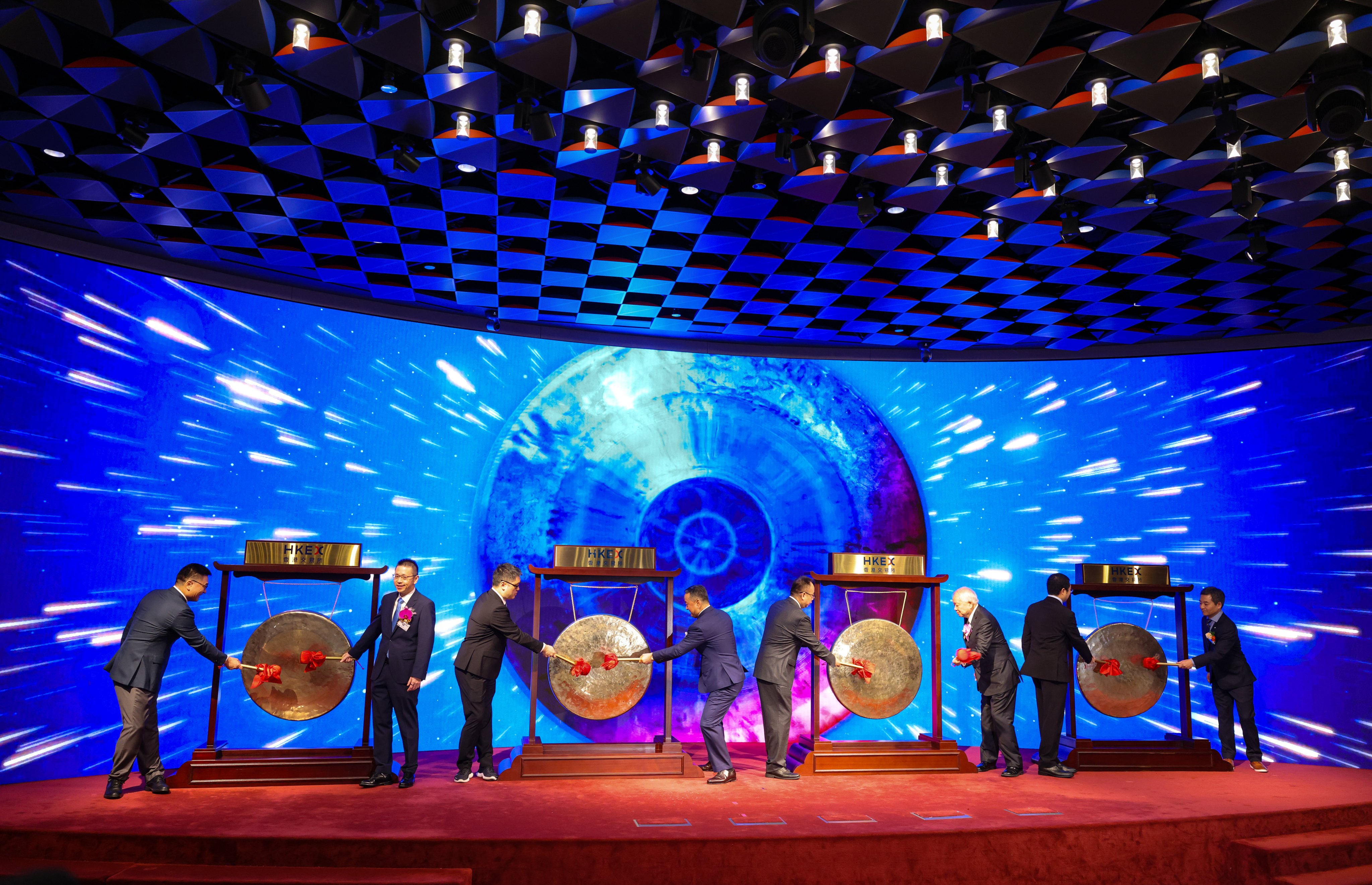 Representatives of four companies bang gongs at the Hong Kong stock exchange to celebrate their share debuts on November 6, 2025. Photo: Nora Tam