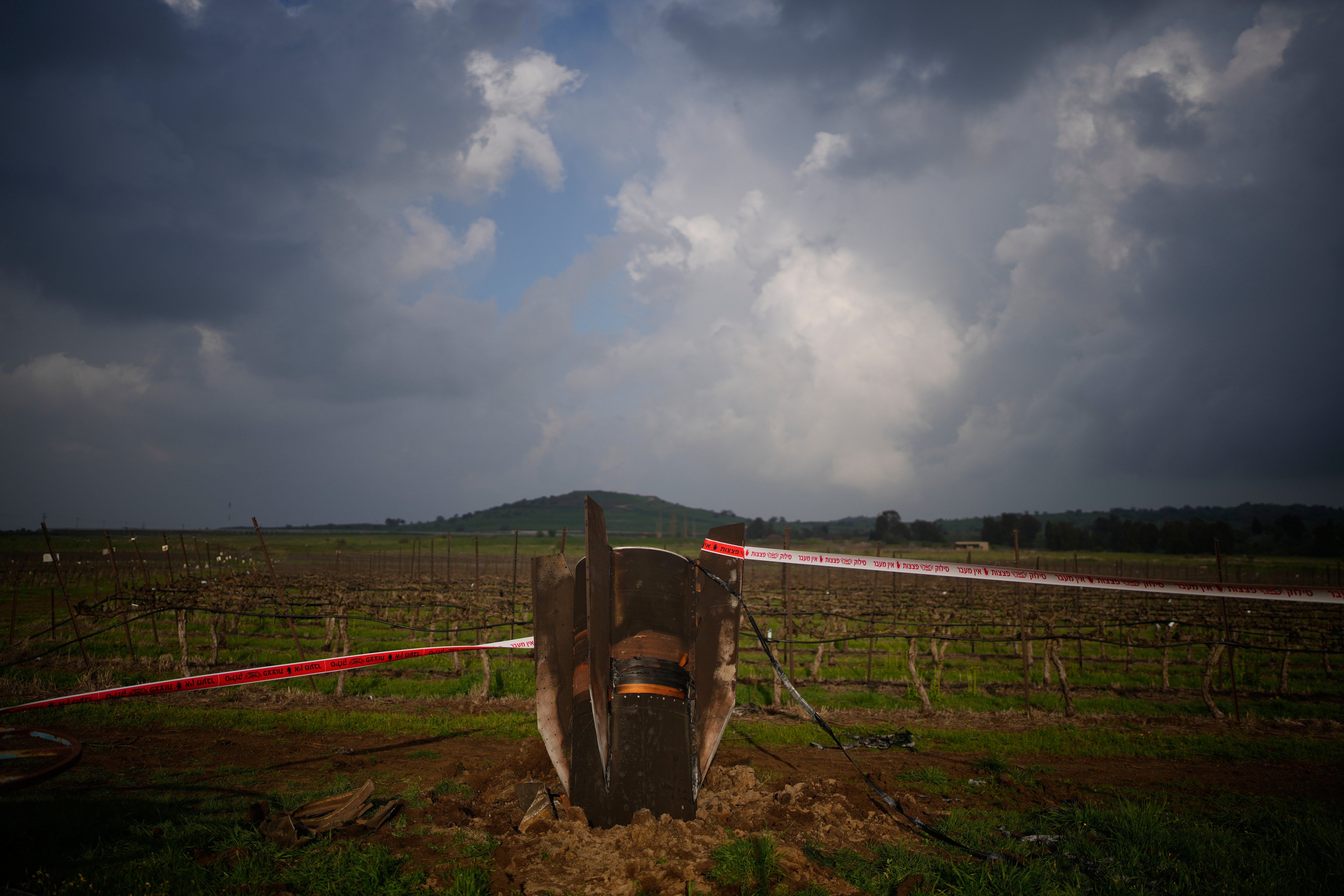 The fragment of a missile fired from Iran, and intercepted by Israel, sticks out in an open field in Israel-controlled Golan Heights. Photo: AP