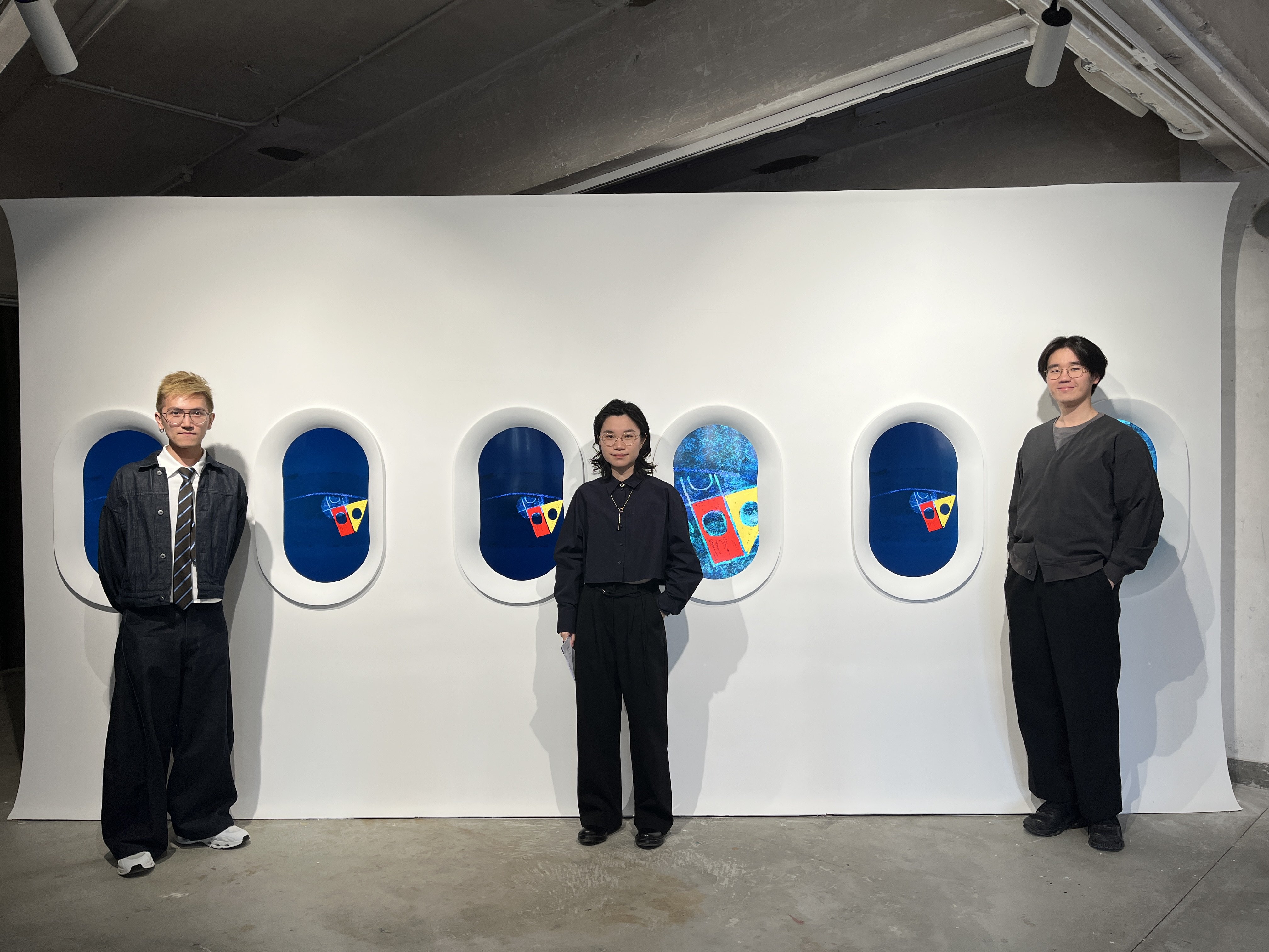 Artist Florence Lee Yuk-ki (middle), the curator Danson Wong (left) and exhibition producer Jackson Kwong (right) photographed in front of Lee’s 2025 work “Where Sight Sinks into Starlit Eyes”. The work is part of Lee’s solo exhibition “Double Blue” at Hart Haus (Photo: Enid Tsui)