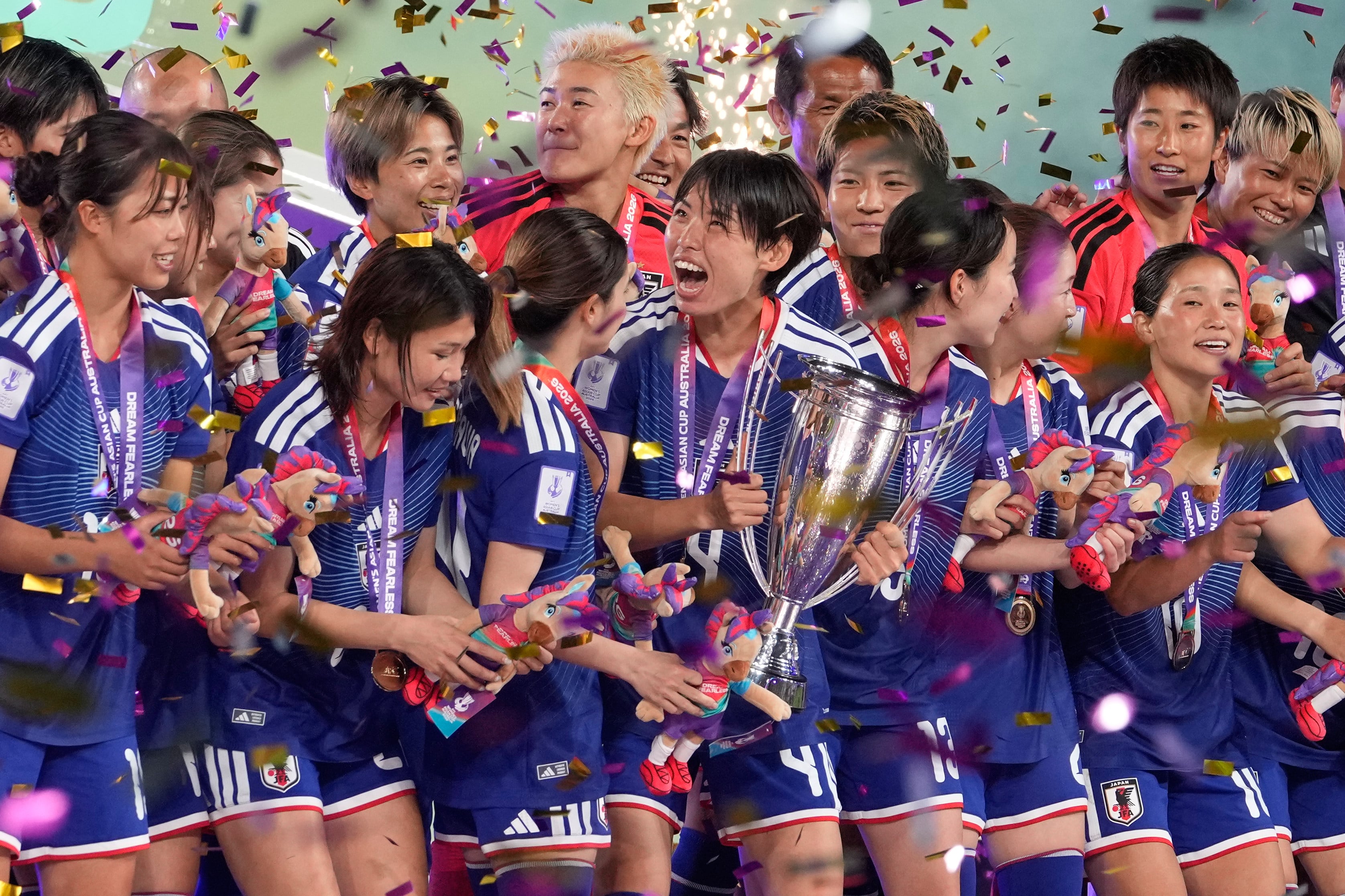 Japan’s Saki Kumagai (centre) and her teammates celebrate with the trophy. Photo: AP