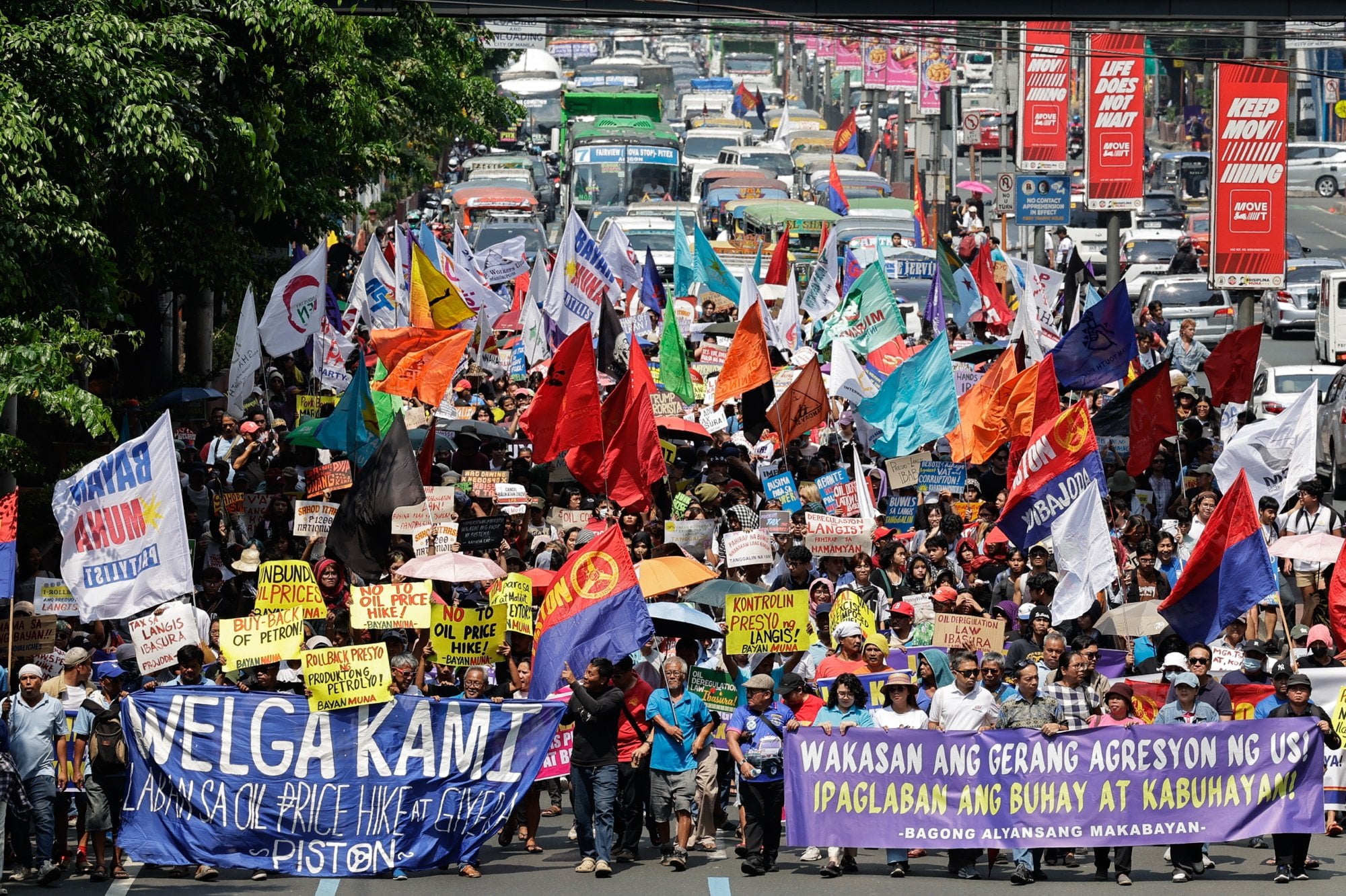 Protesters opposing fuel price hikes walk along a road in Manila, Philippines, on Friday. Photo: EPA-EFE