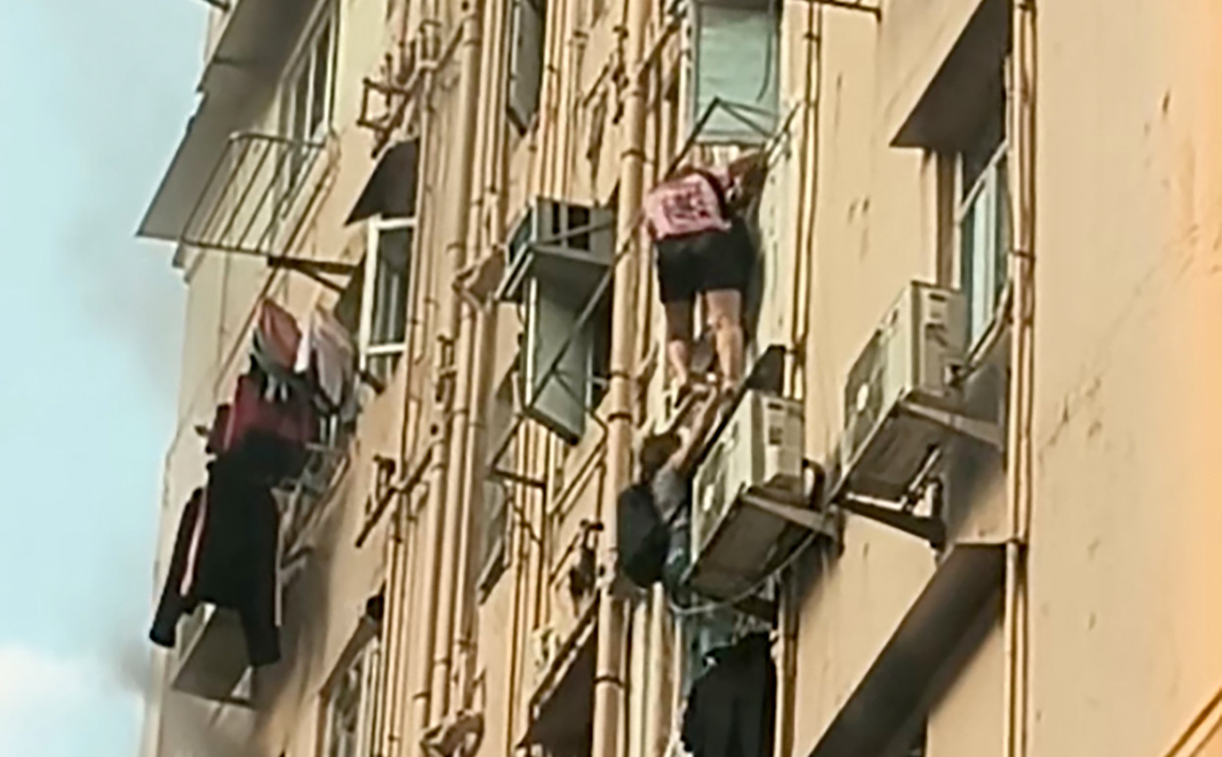 Two residents escaped the fire by climbing down the block. Photo: Handout